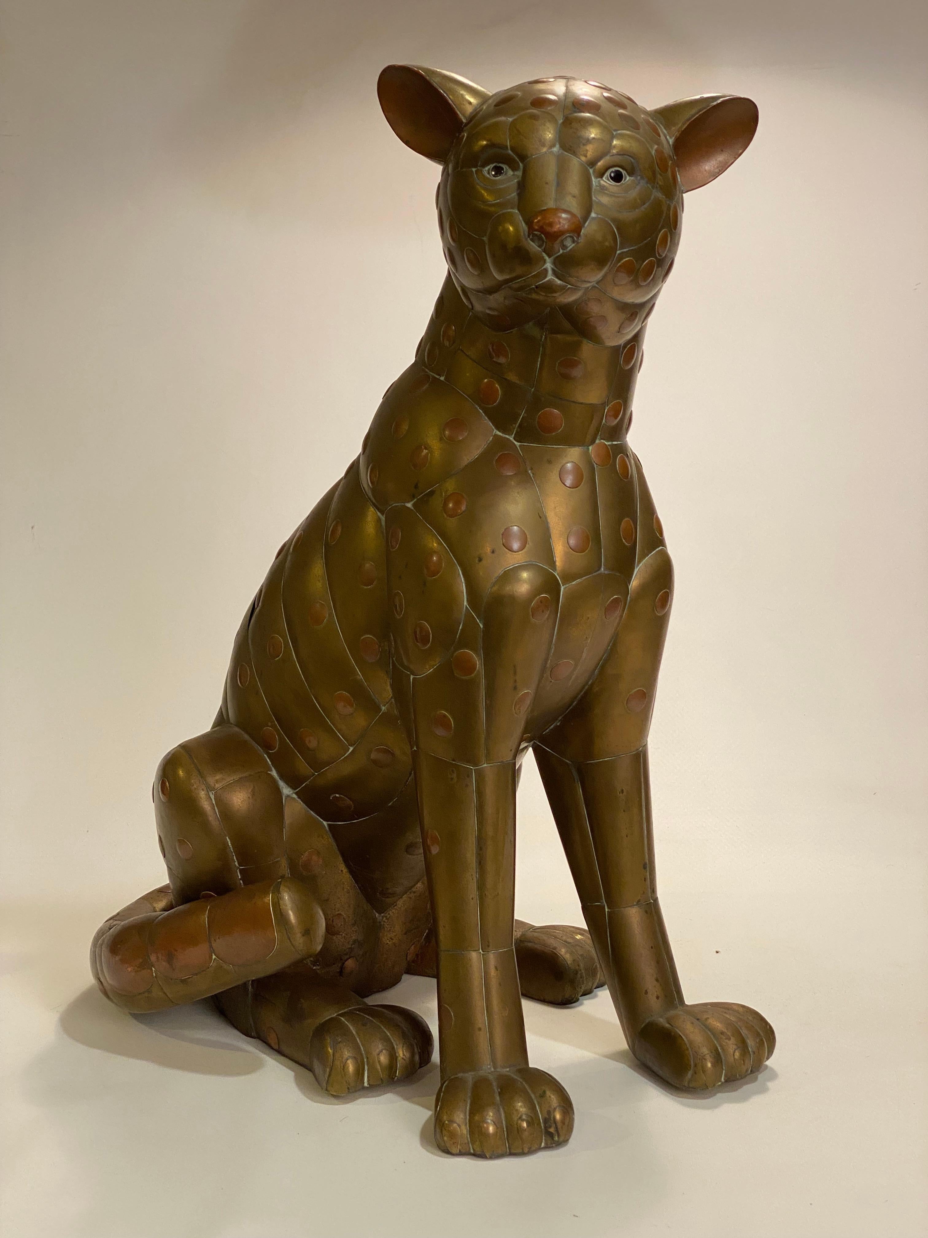 Copper and brass Sergio Bustamante cheetah sculpture. Wonderful attention to detail is the signature to any of Bustamante's animal sculptures. Bustamante and his studio excel at the rendering of feathers or fur, but this piece accentuates the