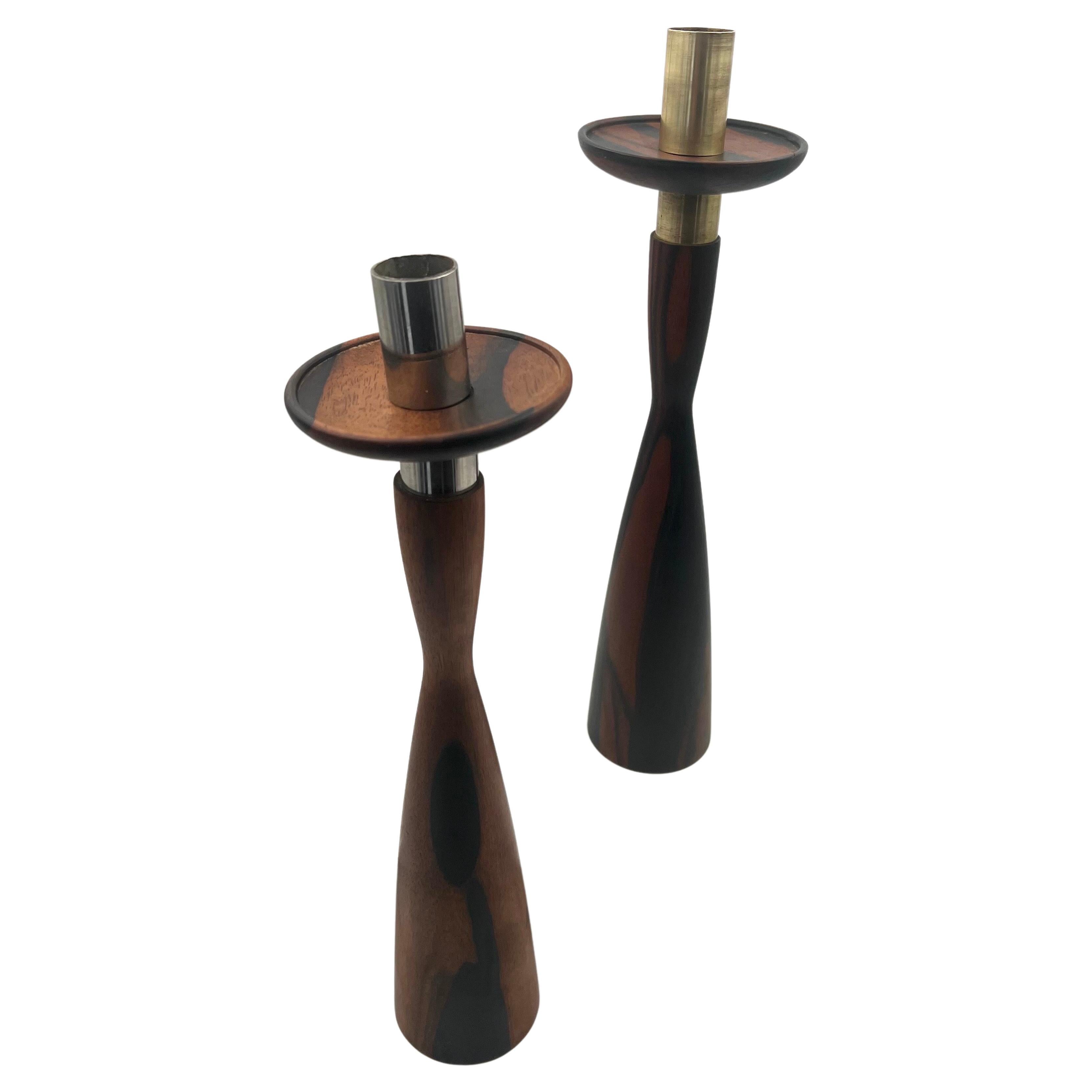 Incredible tall pair of hand-turned candle holders with brass, fittings the grain on the wood its beautiful one shows a brass fitting, and the other a chrome fitting.