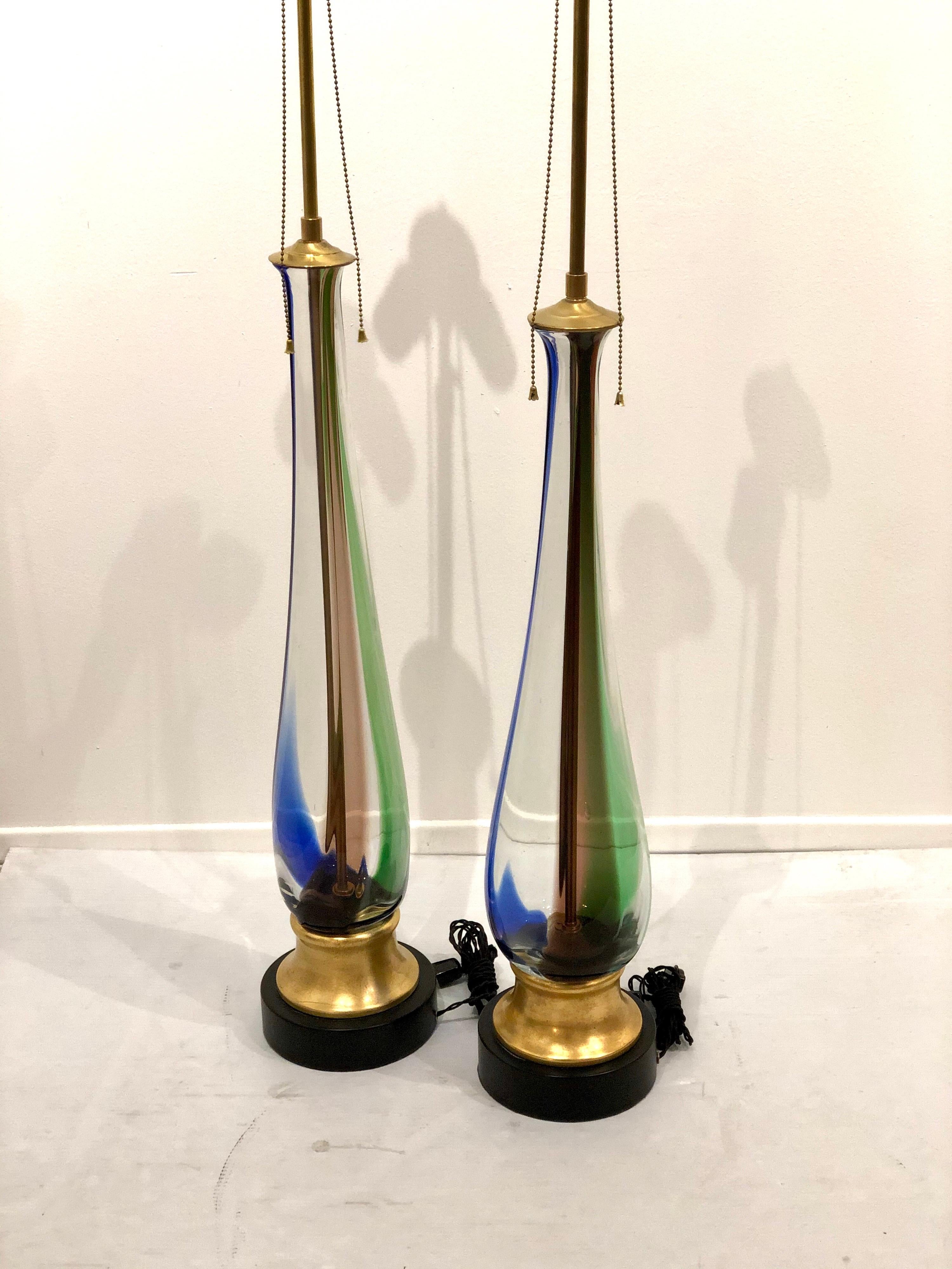 Beautiful impressive pair of table lamps by Murano, Venini freshly rewired gold leaf base double socket that adjust to desirable height, new cloth cord excellent condition lampshades not included. Beautiful colors.