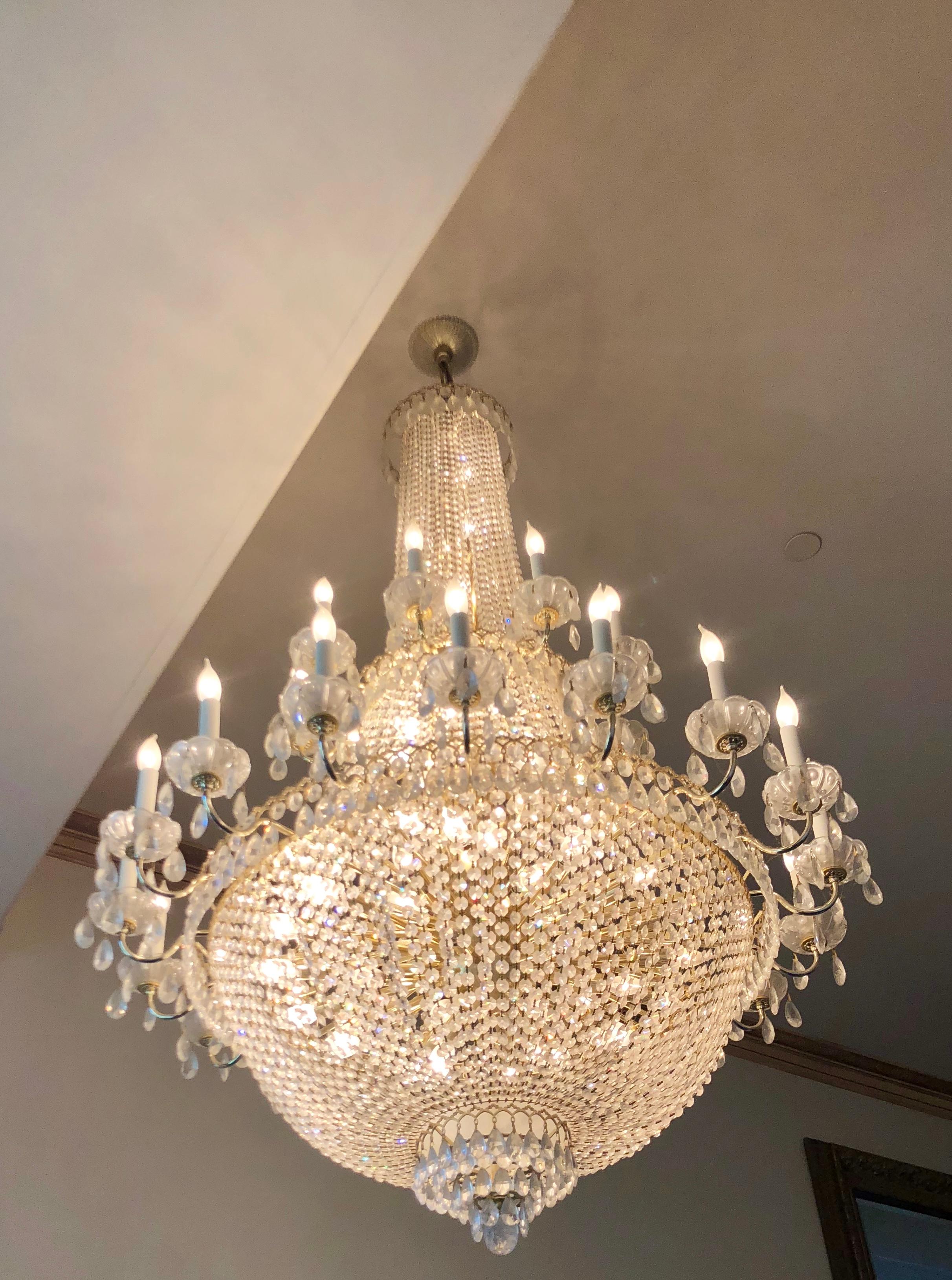 Very elegant, finest quality, estate Schonbek Swarovski Gemcut crystal chandelier features classic Napoleonic Empire style. This stately and magnificent chandelier has two tiers and approximately 84 incandescent lights. It measures 65