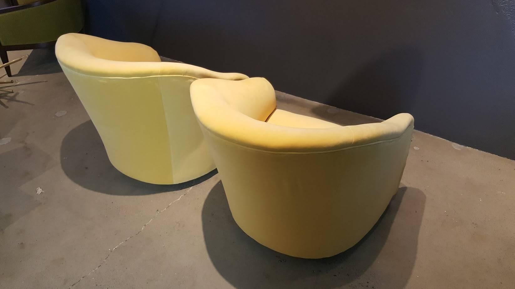 Overscaled and impactful! (And incredibly comfortable, too!) pair of majestic swivel barrel chairs by Ward Bennett, 1960s. These read as a modern take on a club chair. Fully restored (including all new foam) in a luxe canary yellow cotton velvet.