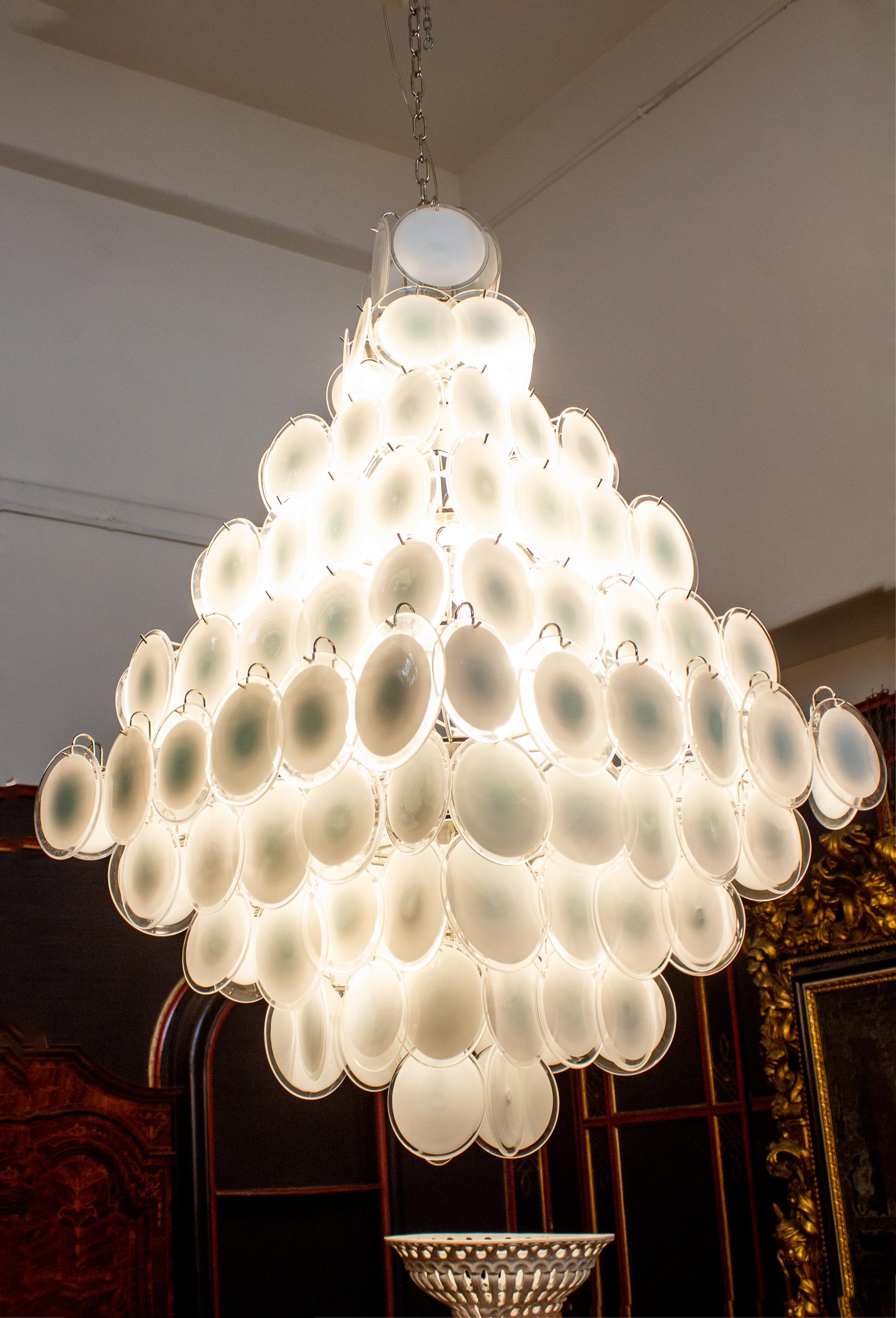 A chandelier of rare beauty and elegance. 134 Murano white
'lattimo' glass discs, disposed in ten rows, forming two overlapping pyramids.
 A pair is available and also with pink discs .
 Available also  3 pairs of sconces .
We can rewire for Us