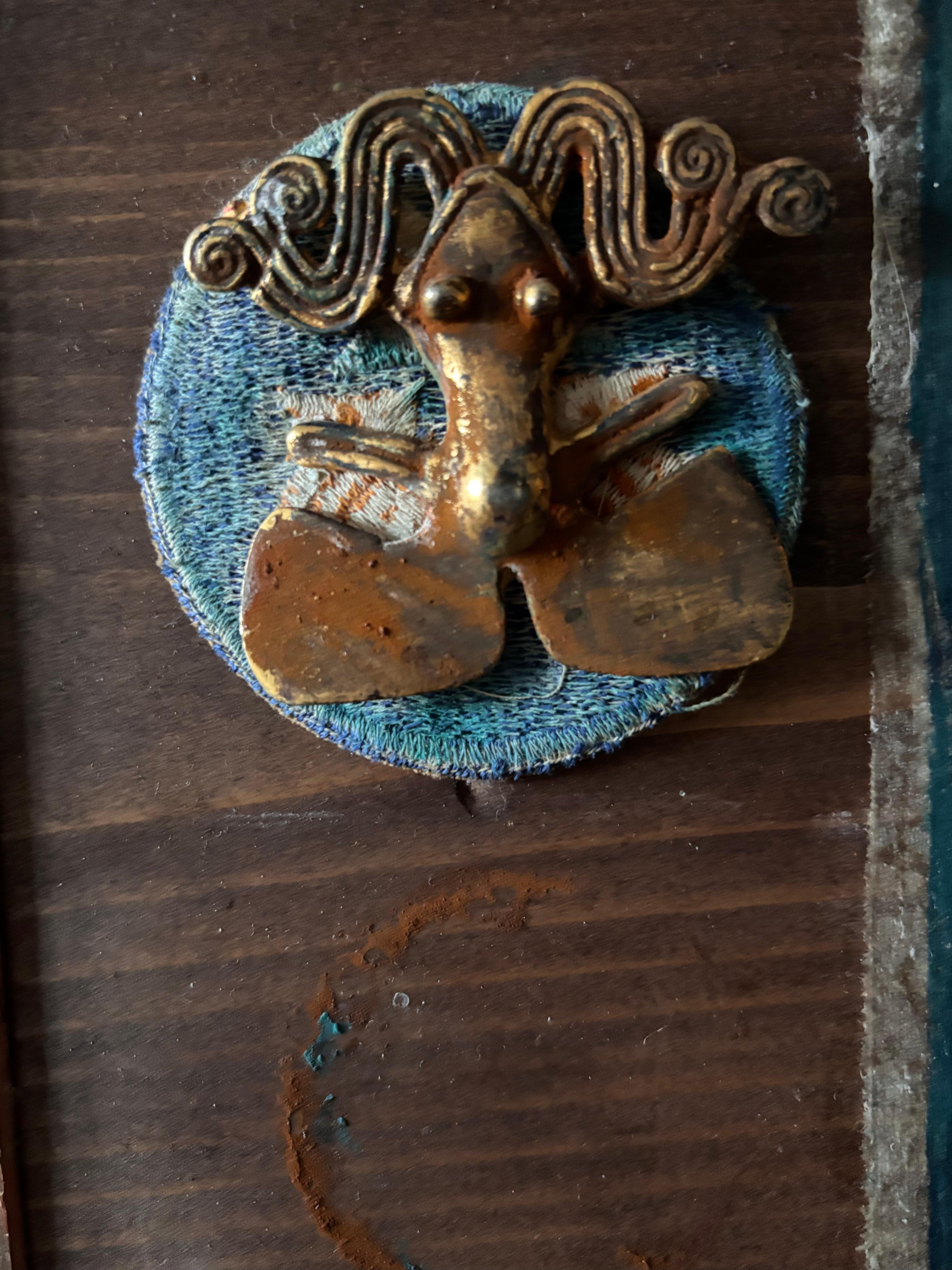 Frog/goddess of transformation is flanked by a single bean believed to carry the souls of ancestors to connect with the past and ensure lineage. 

Our stories are reluctant to change and yet may be/are often changed by the smallest thing. This mixed