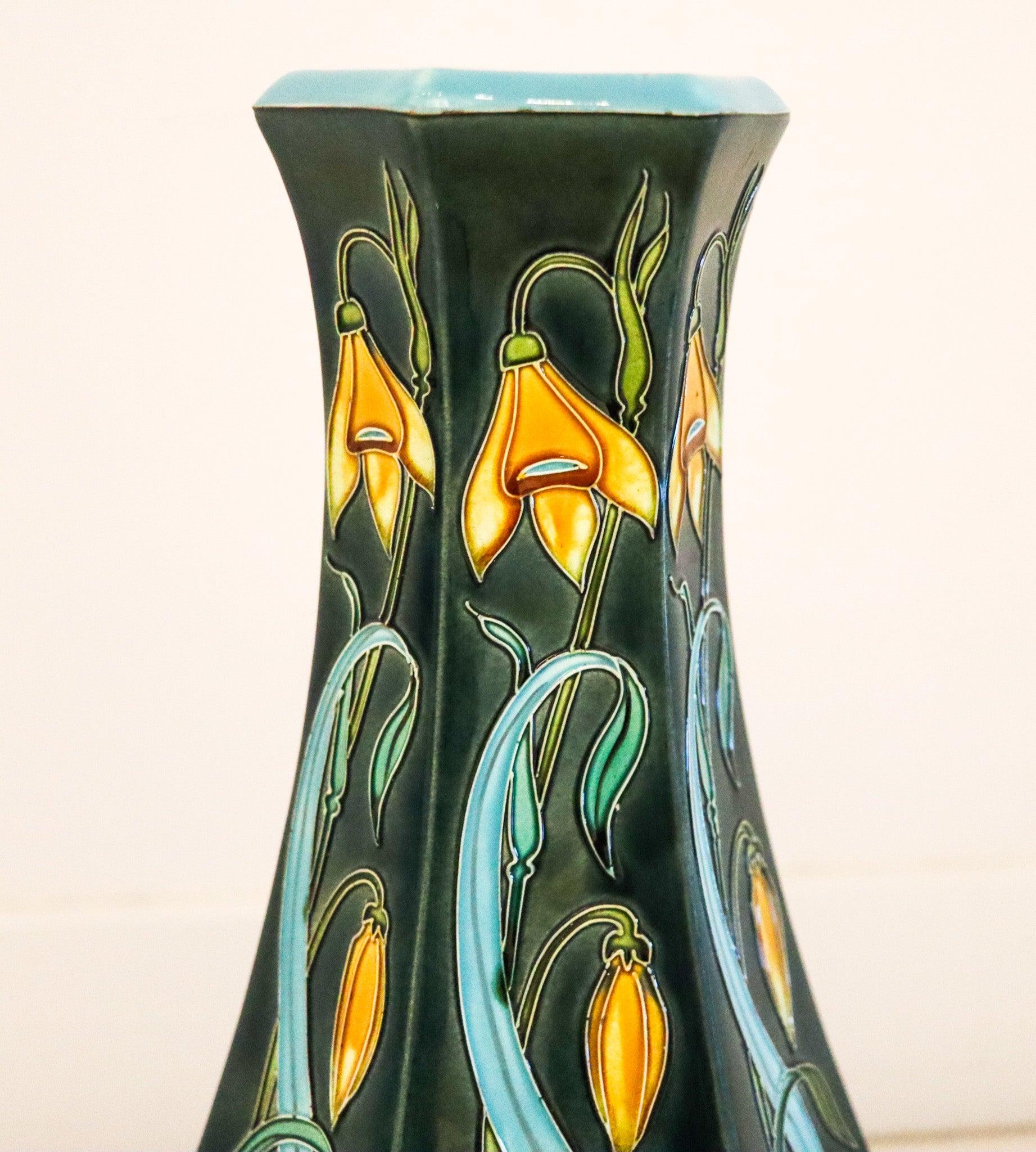 French majolica vase designed by De Longwy.

This is a very nice elaborated tall vase, created in France during the art nouveau period, back in the 1890's. The fabulous decorative vase was crafted with a round base in an hexagonal shape in
