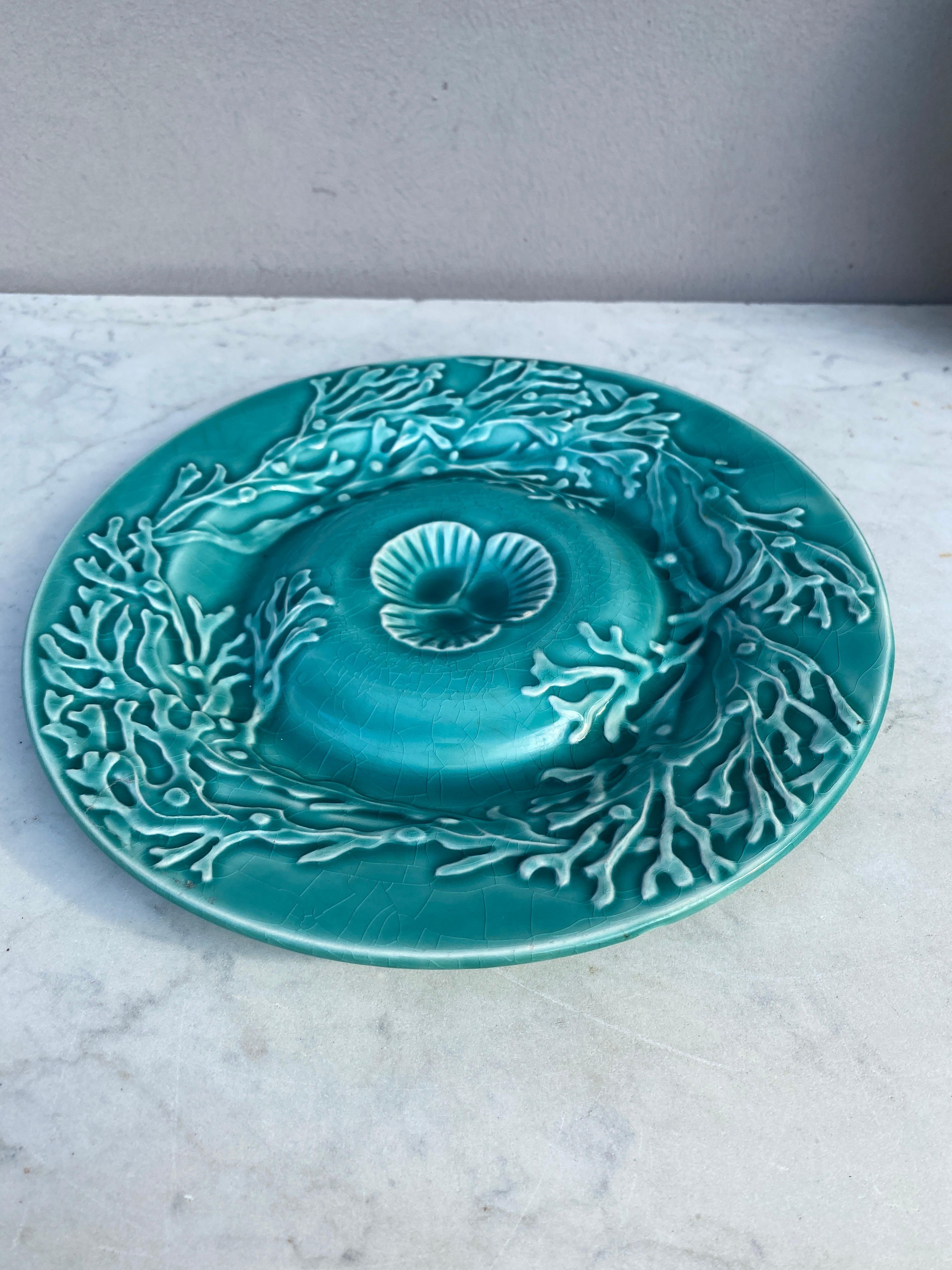 Majolica aqua turquoise shell plate with seaweeds signed Gien, circa 1890.
