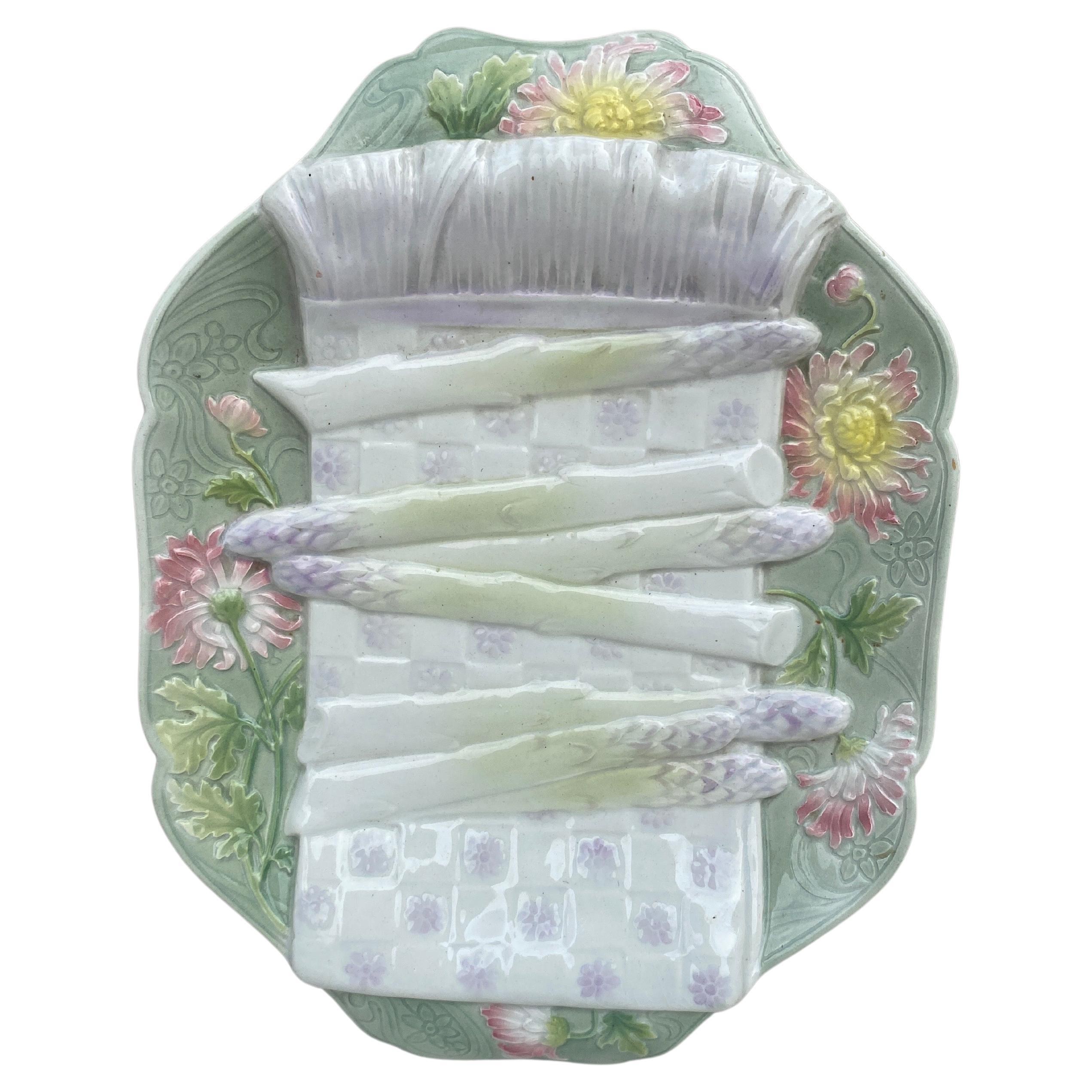 Majolica asparagus platter by Keller and Guerin, manufacturer of Saint Clement, circa 1900.Trompe l’oeil napkin and pink chrysanthemums.