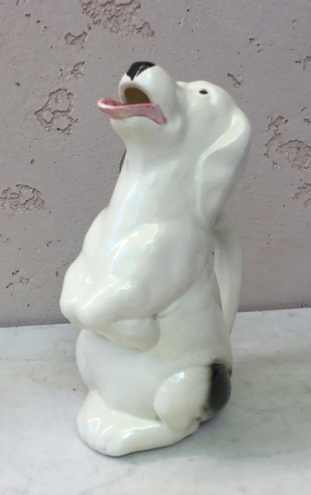 Amusing Majolica white dog with black spots who put out the tongue pitcher signed Sarreguemines, circa 1930.