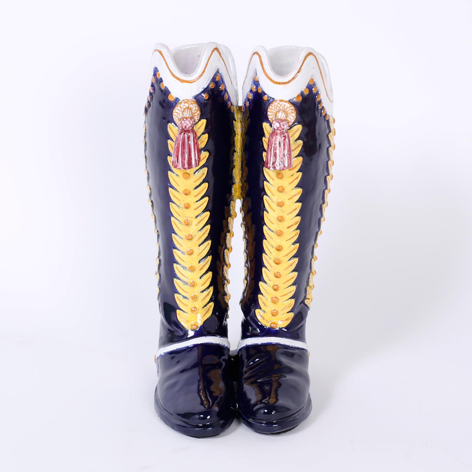 Whimsical midcentury Majolica or glazed terra cotta umbrella or cane Stand in the form of Italian military boots complete with tassels and spurs.