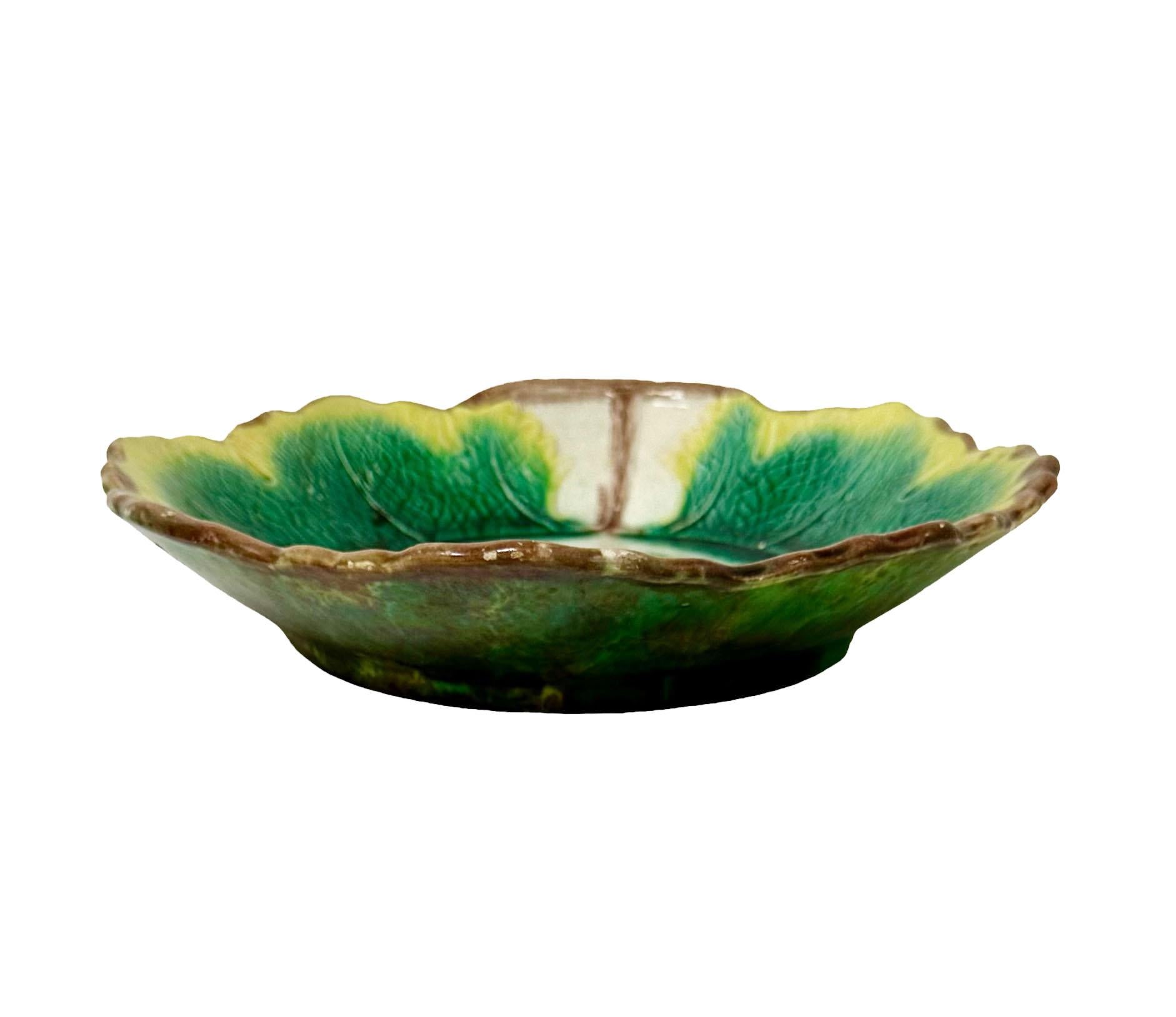 A green Majolica bowl with a beautiful leaf in the center and a scalloped edge. England, circa 1880s.
