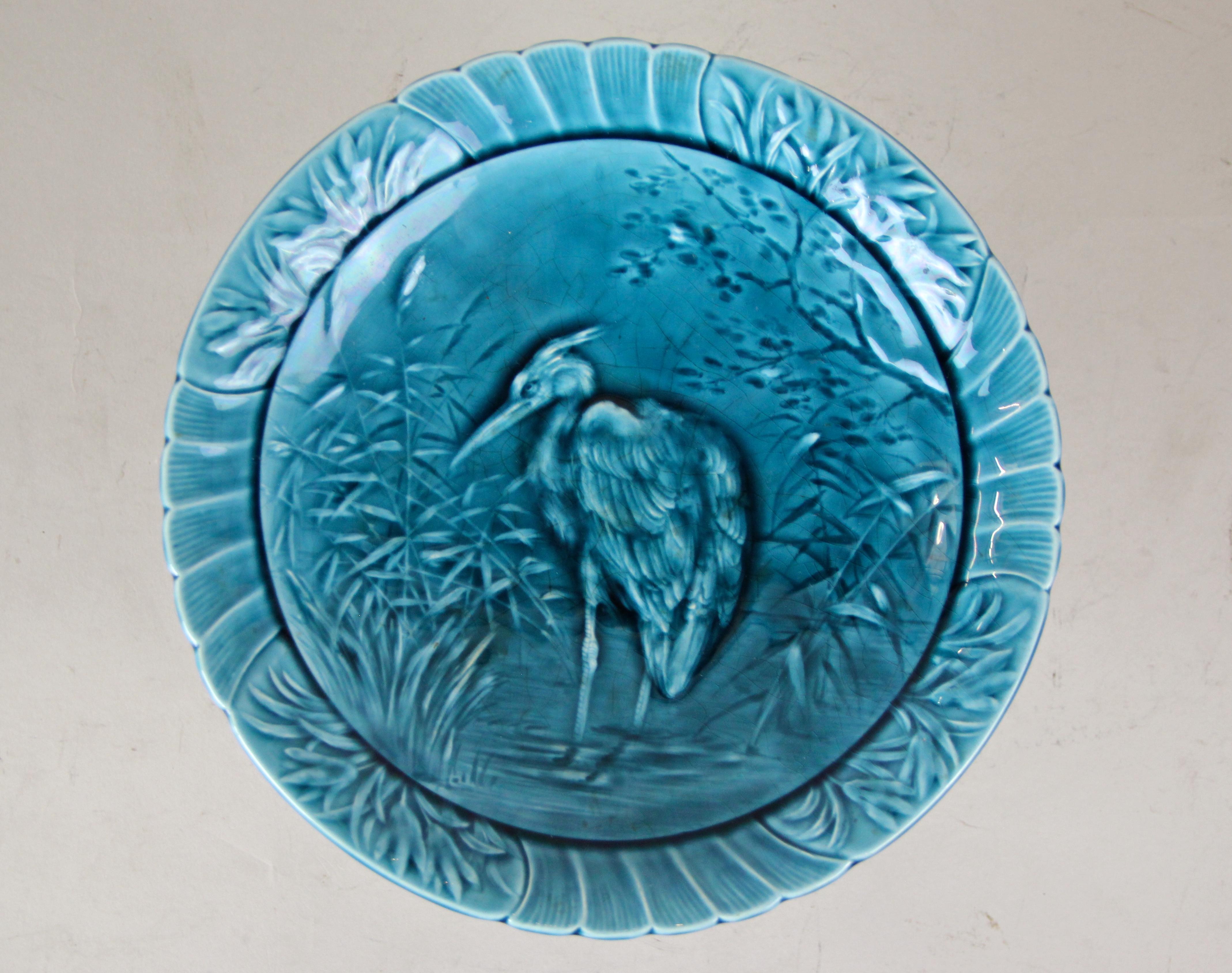Mesmerizing Majolica Centerpiece made by Sarreguemines in France, circa 1915. A very decorative piece of Majolica art depicting a heron on the top plate. Designed with much love to details this early 20th century Majolica centerpiece convinces with