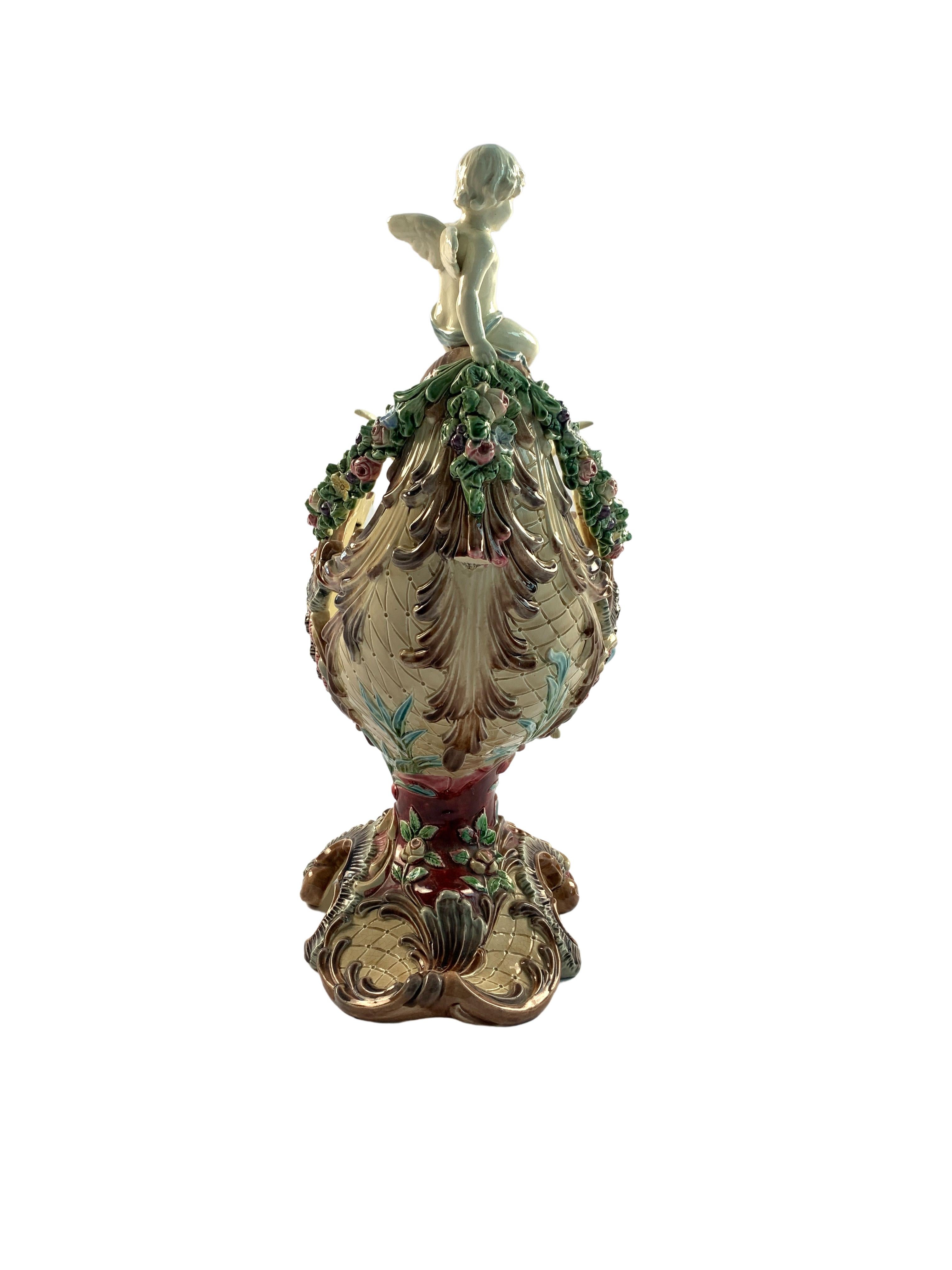 Majolica centrepiece in form of nautilus shell garlanded with flowers and pulled by winged horse and robed maiden, Cupid figure seated on stern, in the style of Dressler, Schiller and Fischer Budapest, imprinted four-digit number underneath