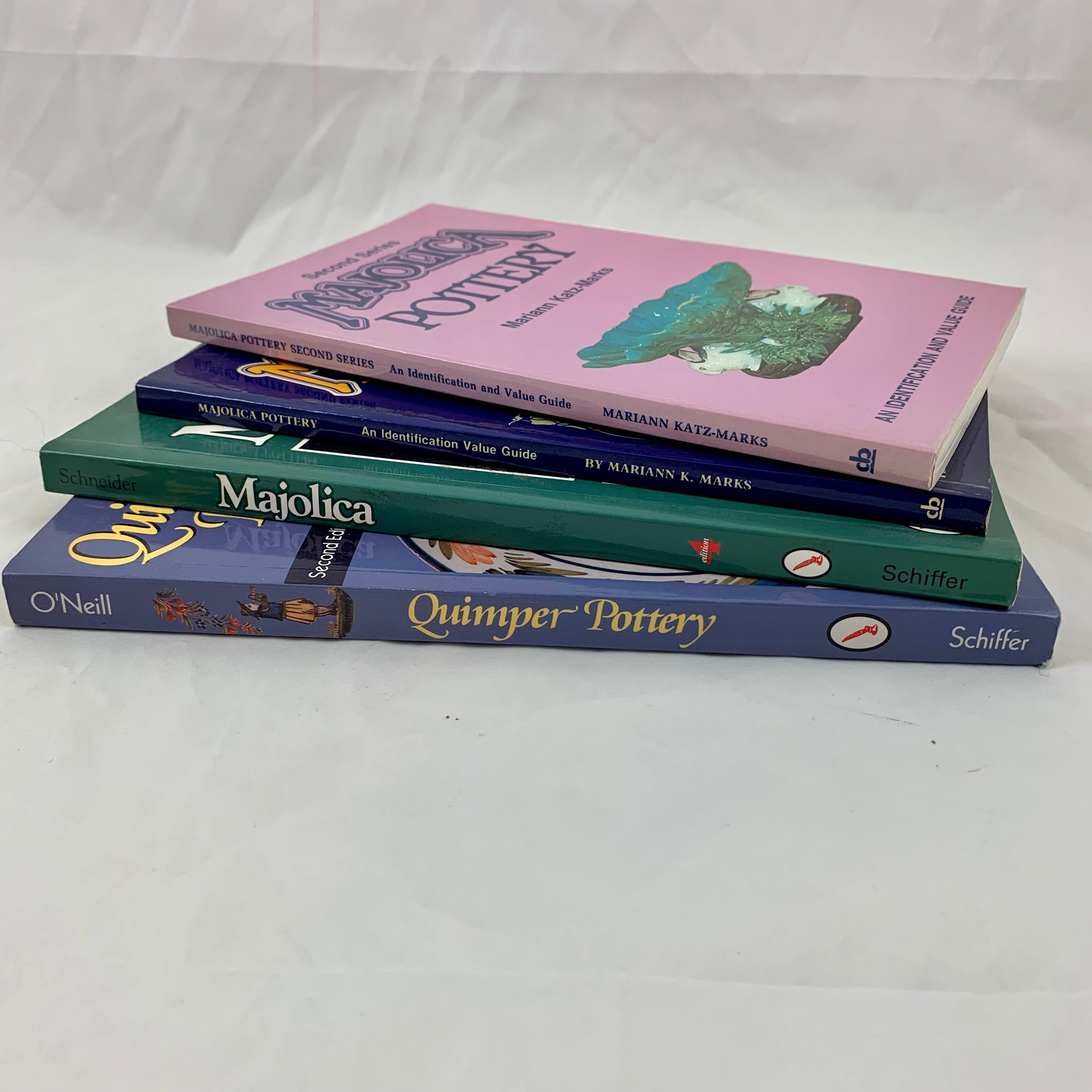 A group of four soft-bound, full-color collector's reference books, three books on English, Continental, and American Majolica and one book covering French Quimper pottery. They are a valuable, in-depth and informative reference for both the