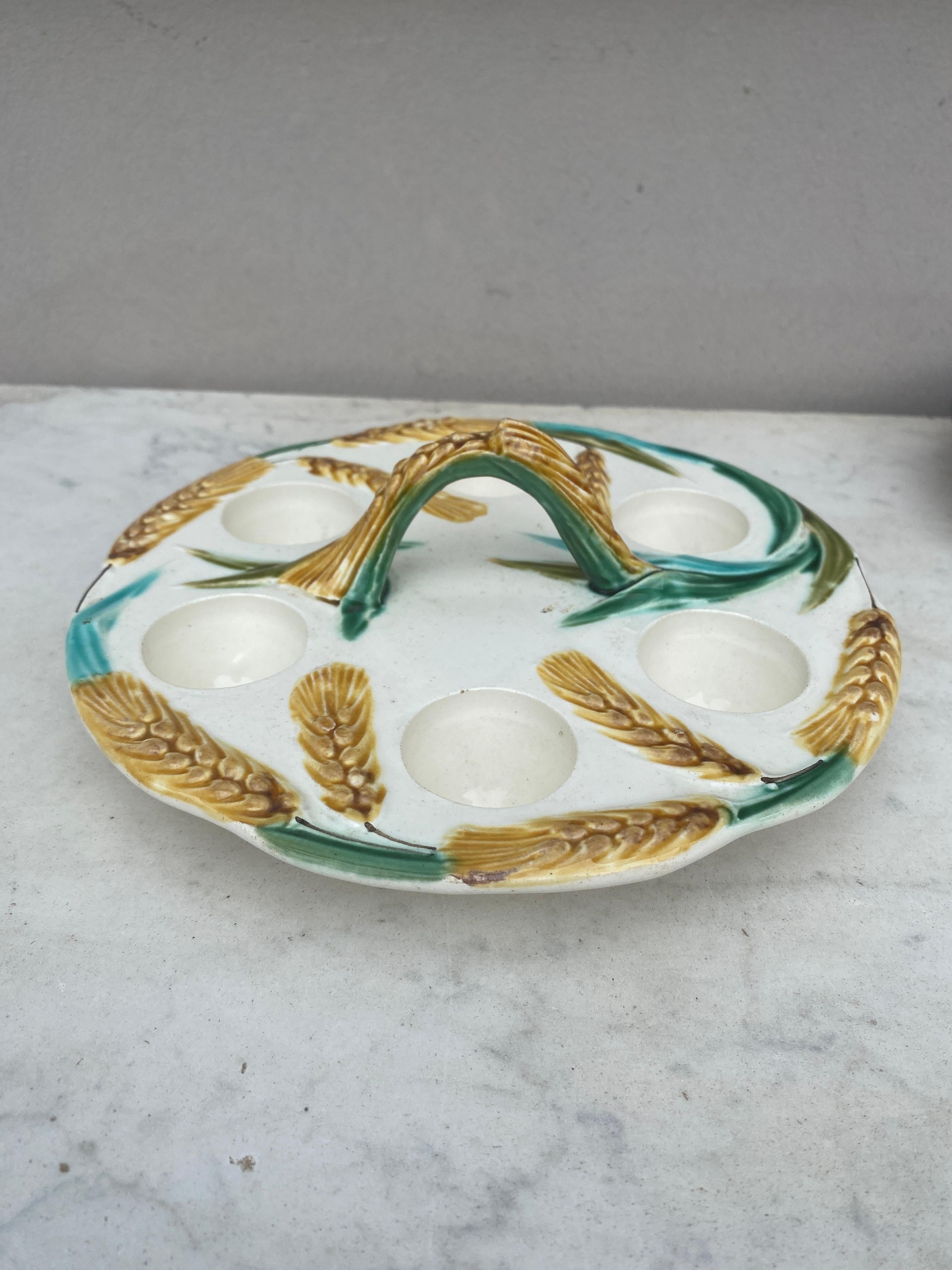 Antique French Majolica wheat egg plate with handle, circa 1900.