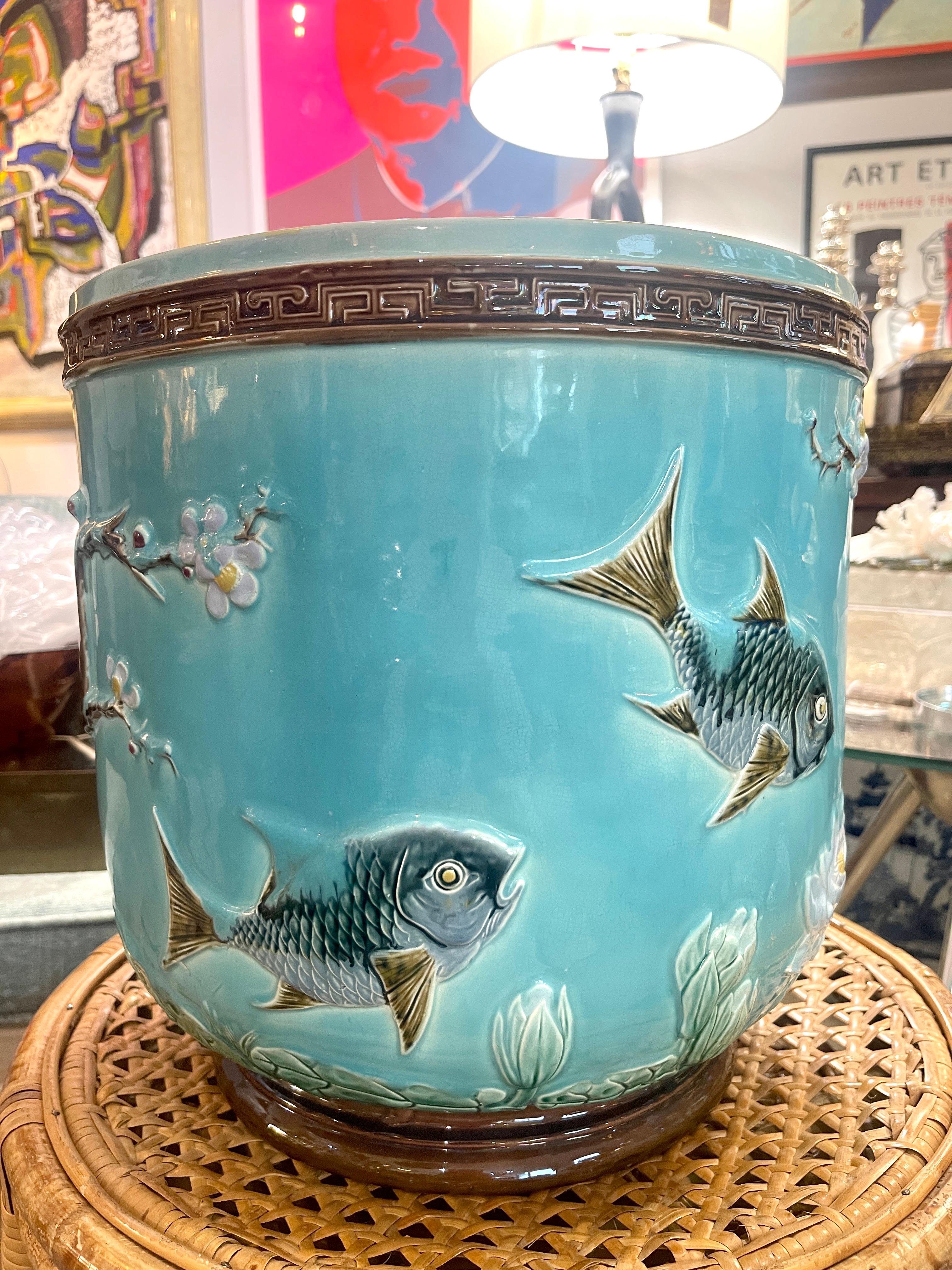 Just in!
This fabulous and large Majolica jardinière or planter with Swimming Fish and  white Lotus  flowers on branches on a turquoise background and Greek Key border.
.This planter has all the bells and whistle of a major Majolica piece by Joseph