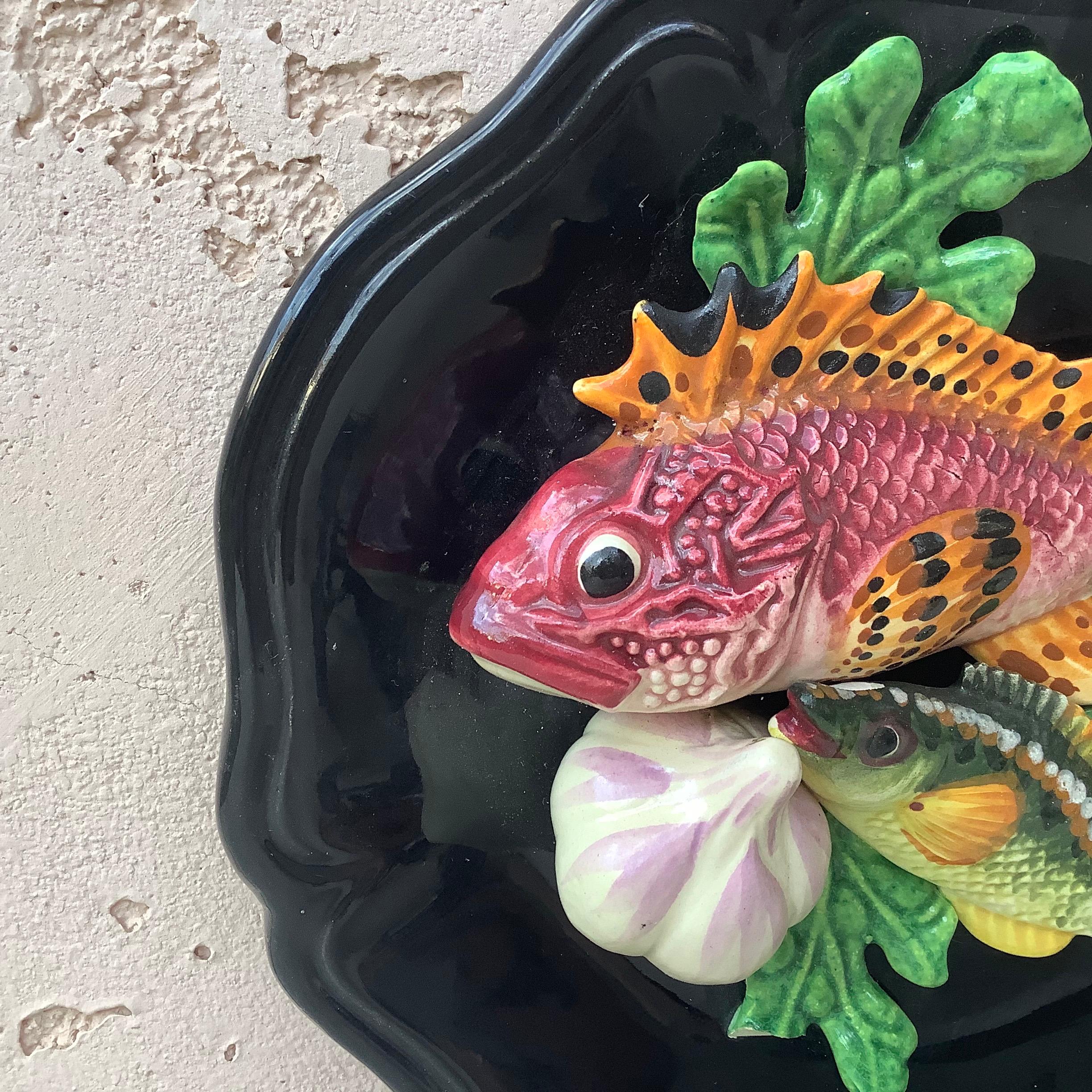 French Majolica fish platter. Decorated with fishes, seaweed, garlic, circa 1950.
   