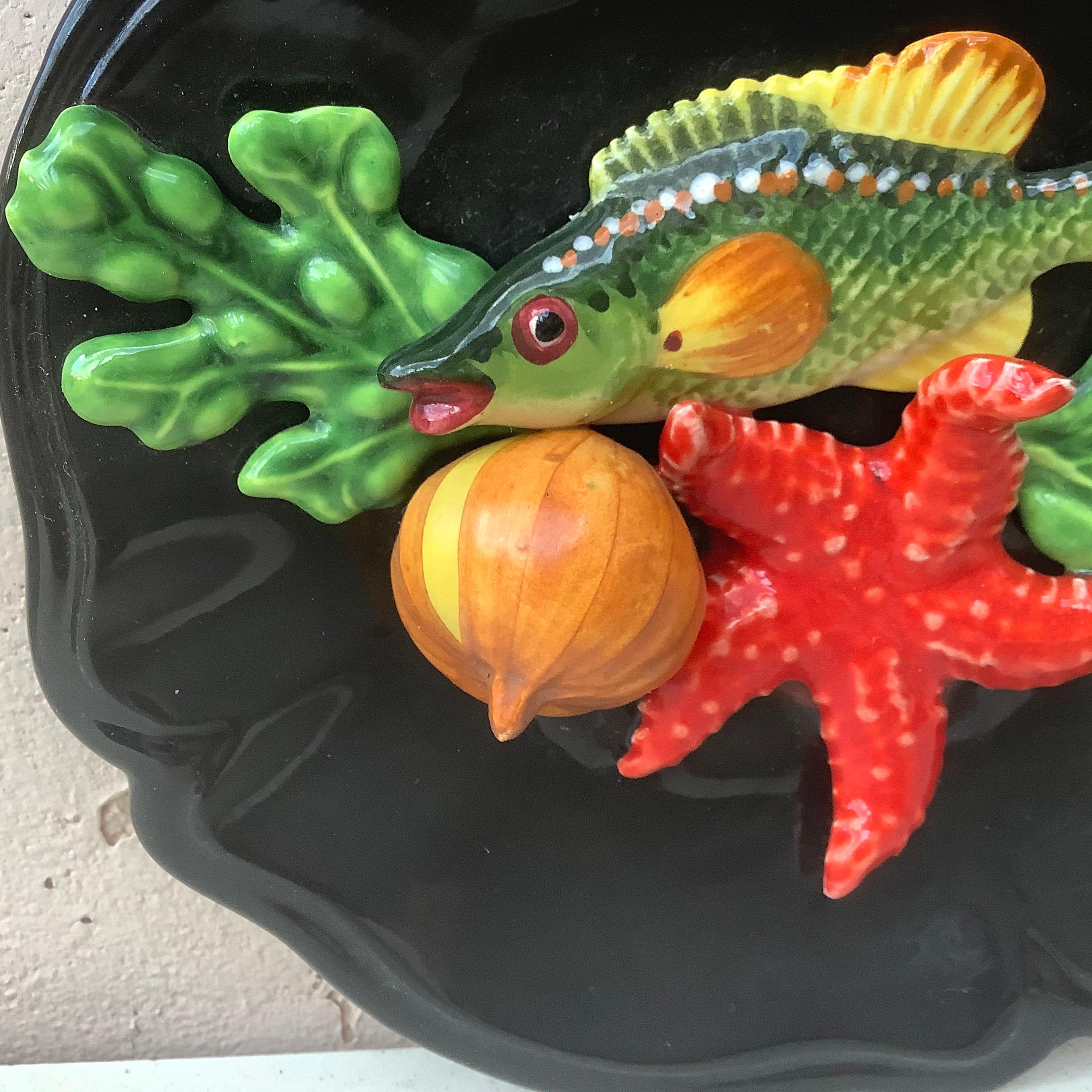 French Majolica fish platter. Decorated with starfish, seaweed, onion, circa 1950.
   