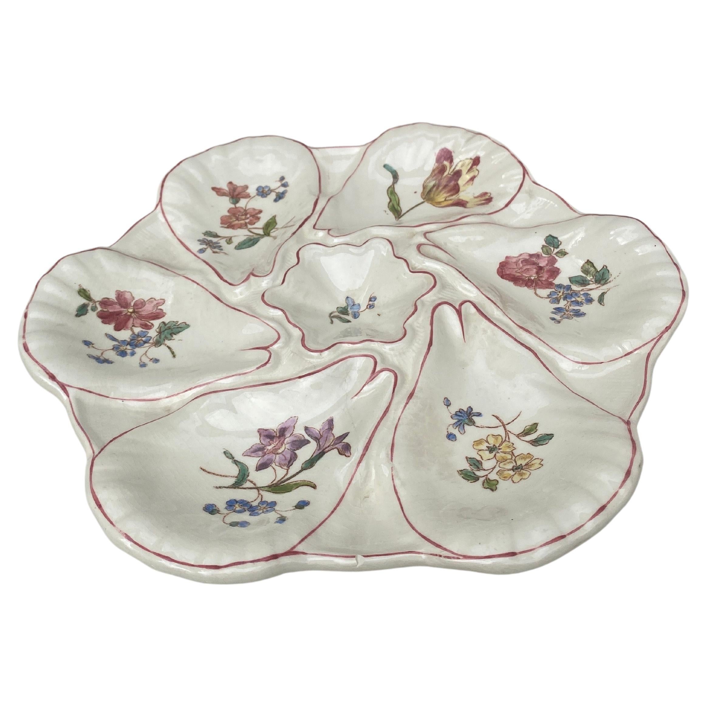 Majolica oyster plate with different flowers on each shells, circa 1900 signed Longchamp.
Hairline.
 