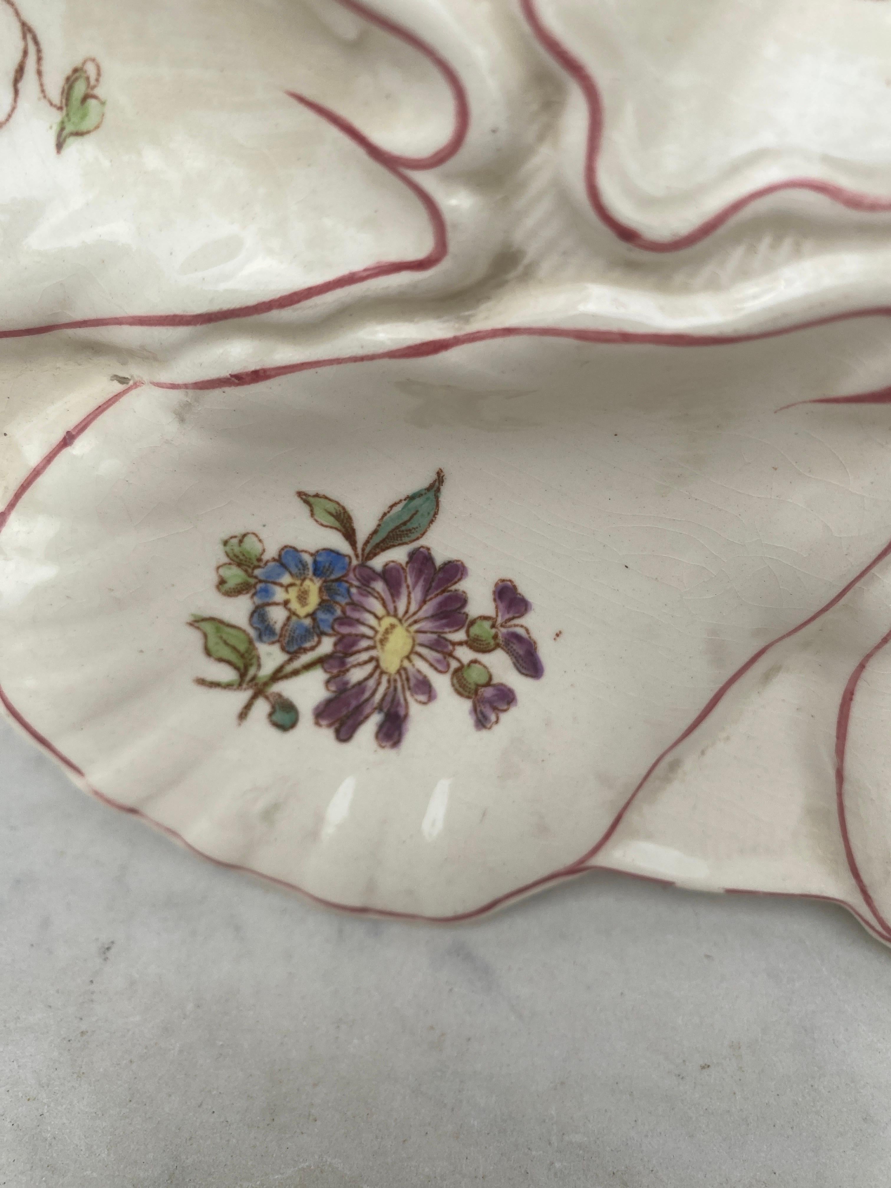 Majolica oyster plate with different flowers on each shells, circa 1900 signed Longchamp.
 
