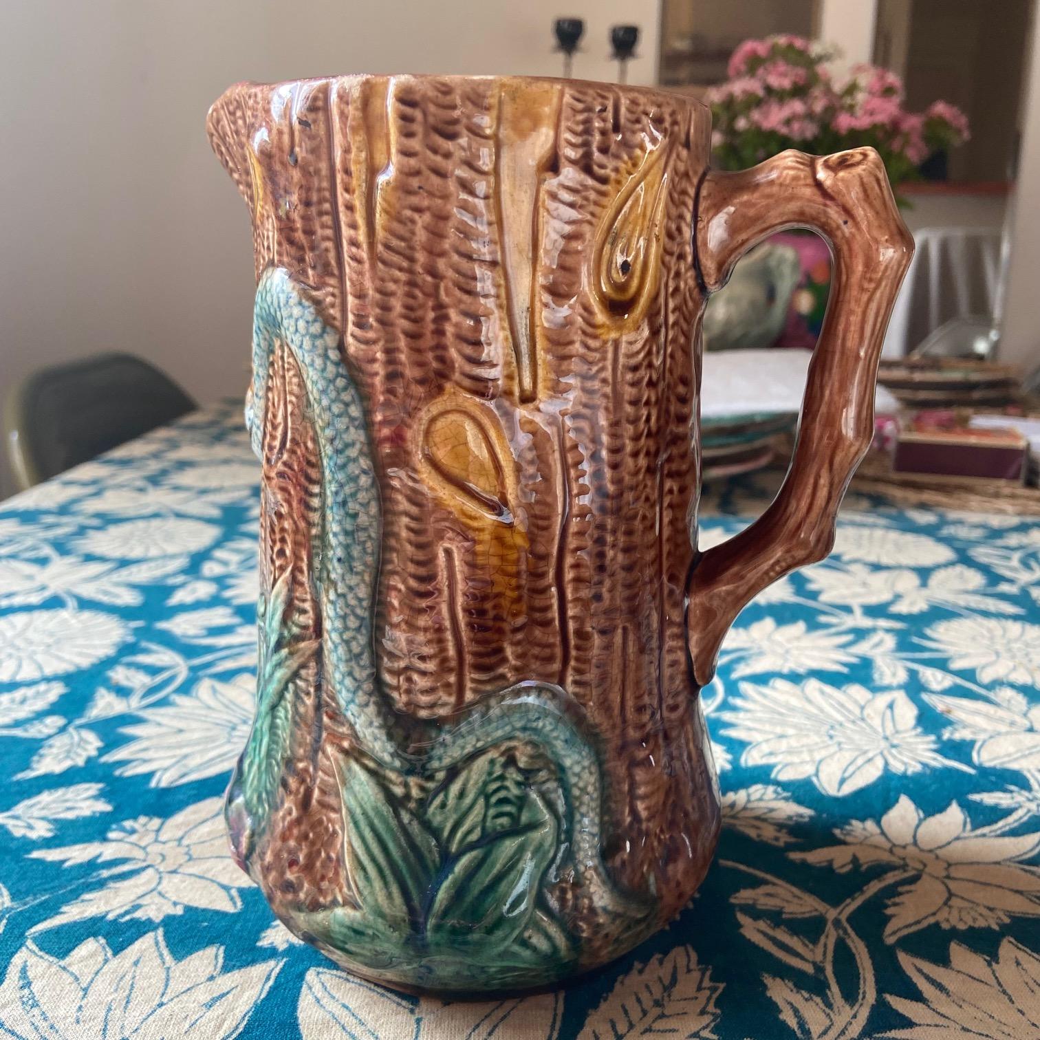 Atypical majolica pitcher with two snakes in a leafy and woody environment.
A true find for a majolica collector !