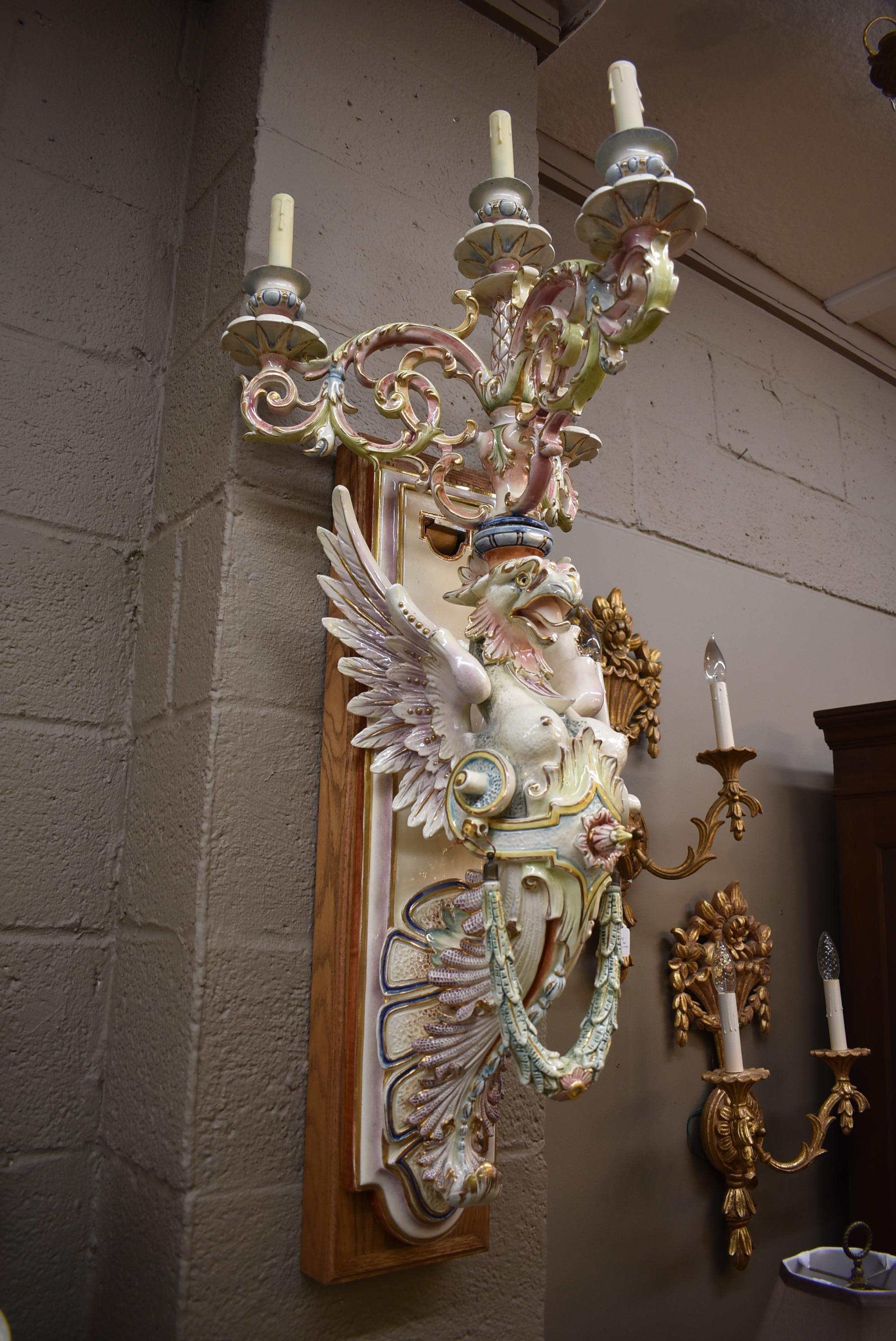 Oversize Majolica glazed porcelain winged lion wall sconce candelabra with four sockets.