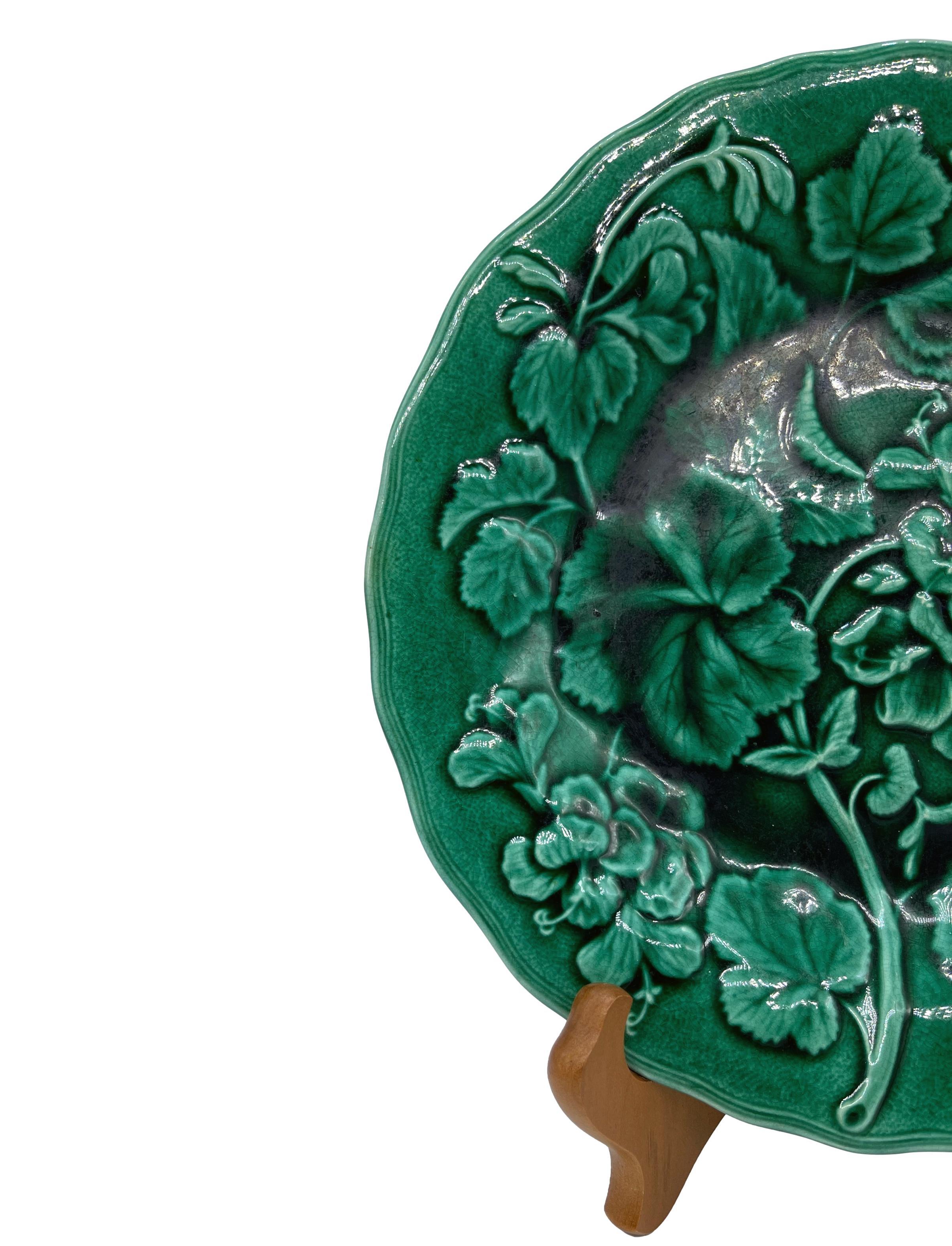 English majolica green-glazed 9-inch plate, with relief molded geranium plants and blossoms and shaped rim, the reverse with impressed mark 'HOPE & CARTER, ENGLAND,' ca. 1880.
For thirty years we have been among the preeminent specialists in fine