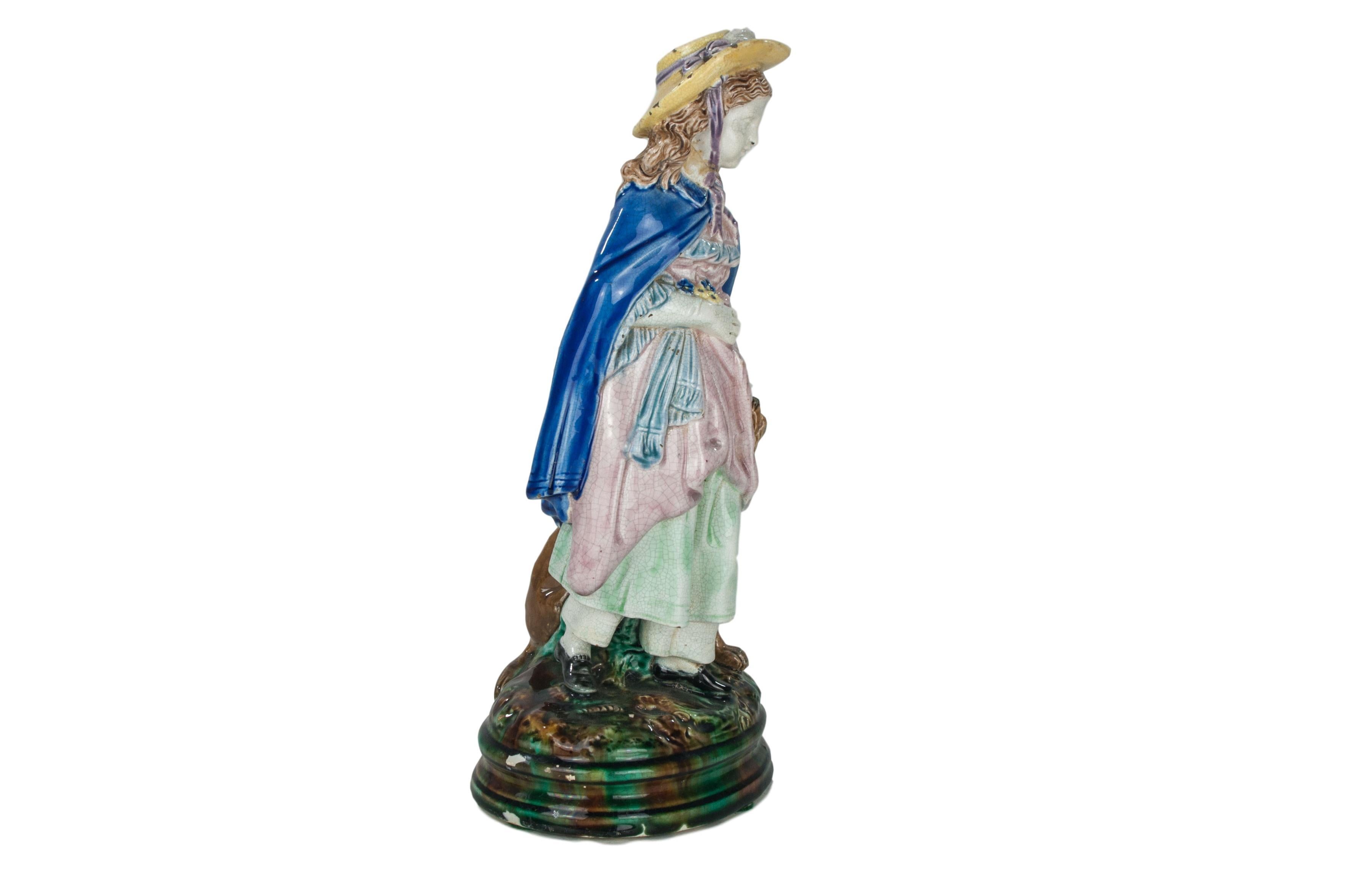  Joseph Holdcroft Majolica Figure of a Little Girl and Dog, English, ca. 1880.  
Good condition with two small chips (pictured) to the rear pedestal base.  
For over 28 years we have been among the nation's preeminent specialists in fine antique