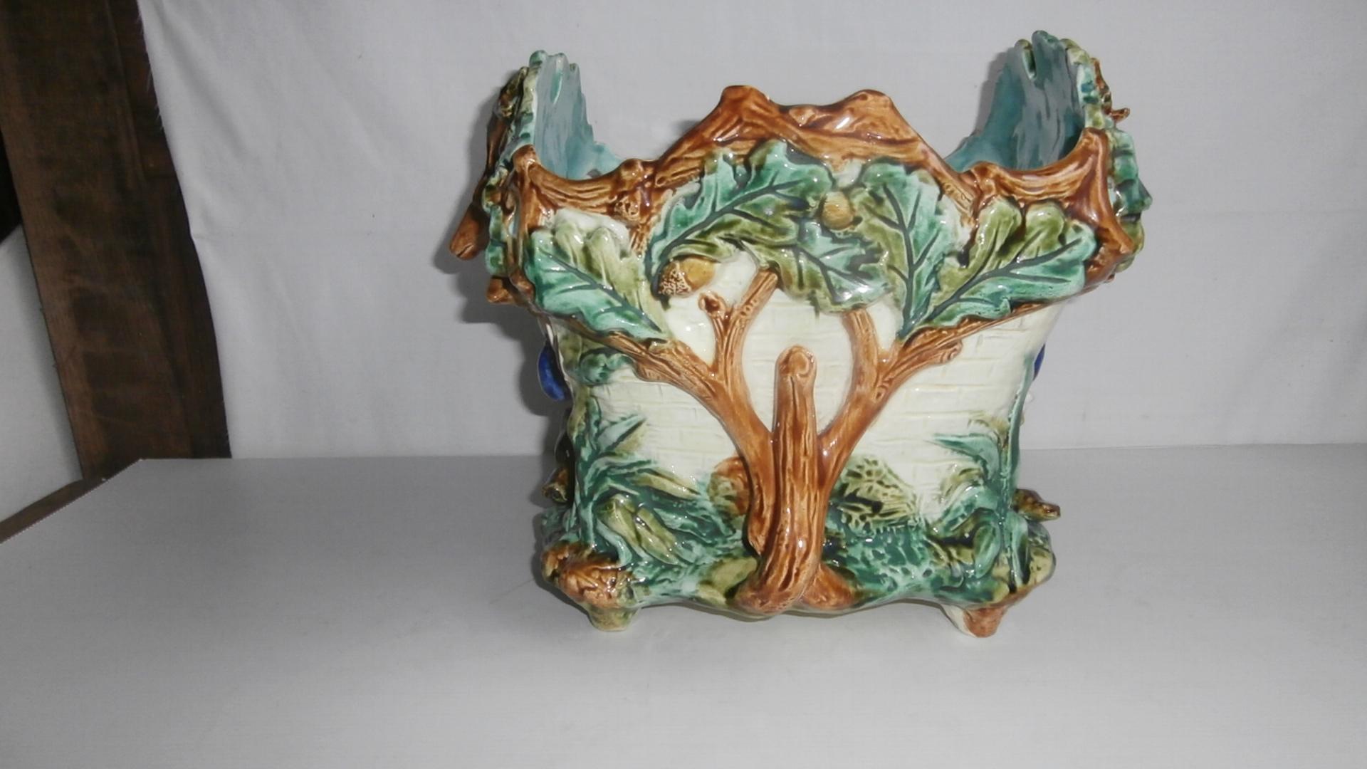 19th century square Majolica hunt jardinière signed Onnaing.
The planter is decorated with a deer head on the front, oak leaves and acorns, hunting symbols ( gamebag, horn and carbine) on the front also a boar head and a goose.
Measures: 9 3/4 x