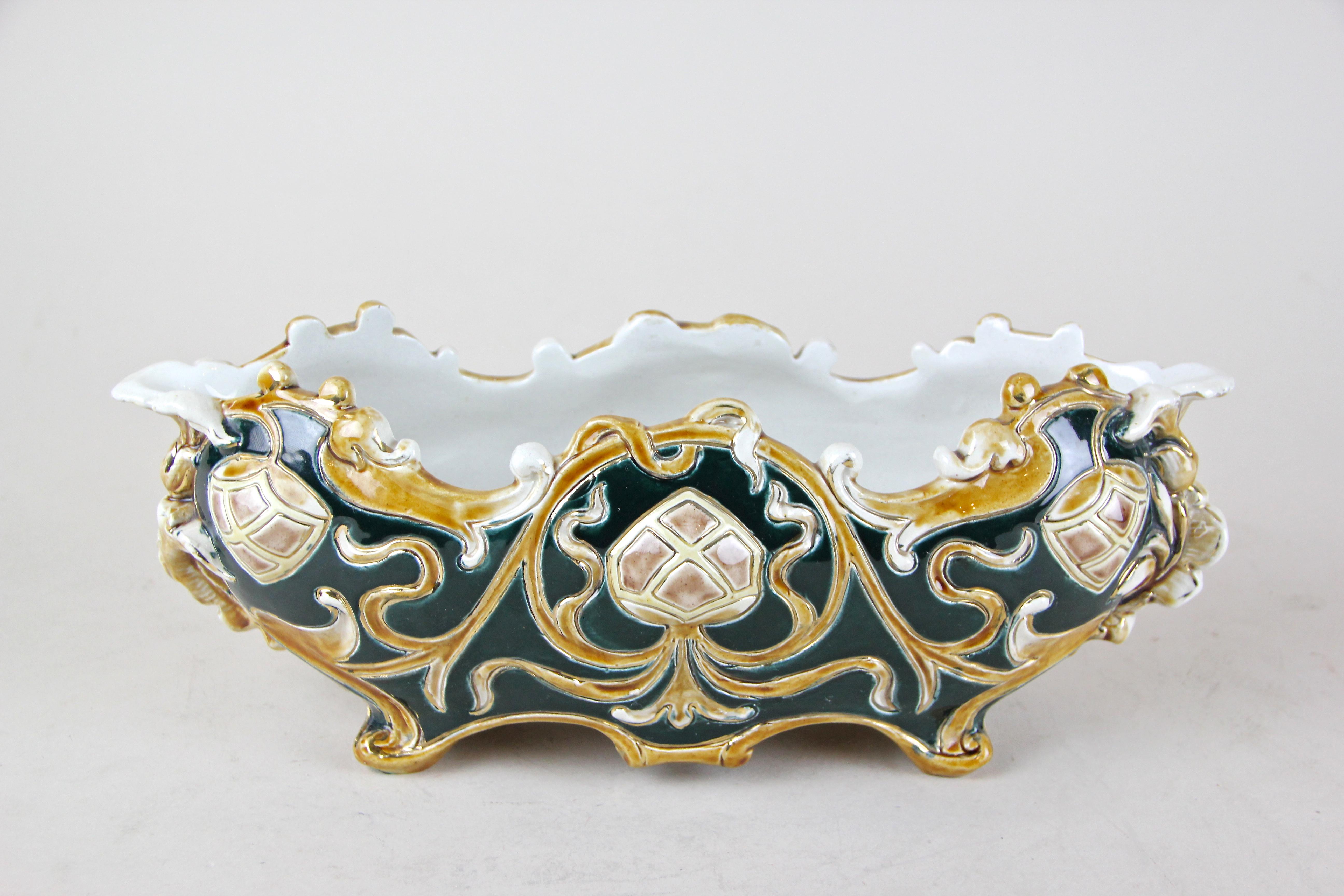 Beautiful shaped Majolica Jardinière produced by the famous ceramic/ majolica manufacturer Wilhelm Schiller & Son around 1890. This majolica piece shows an amazing floral, hand-painted design and wonderful coloration in dark blue/green and brown