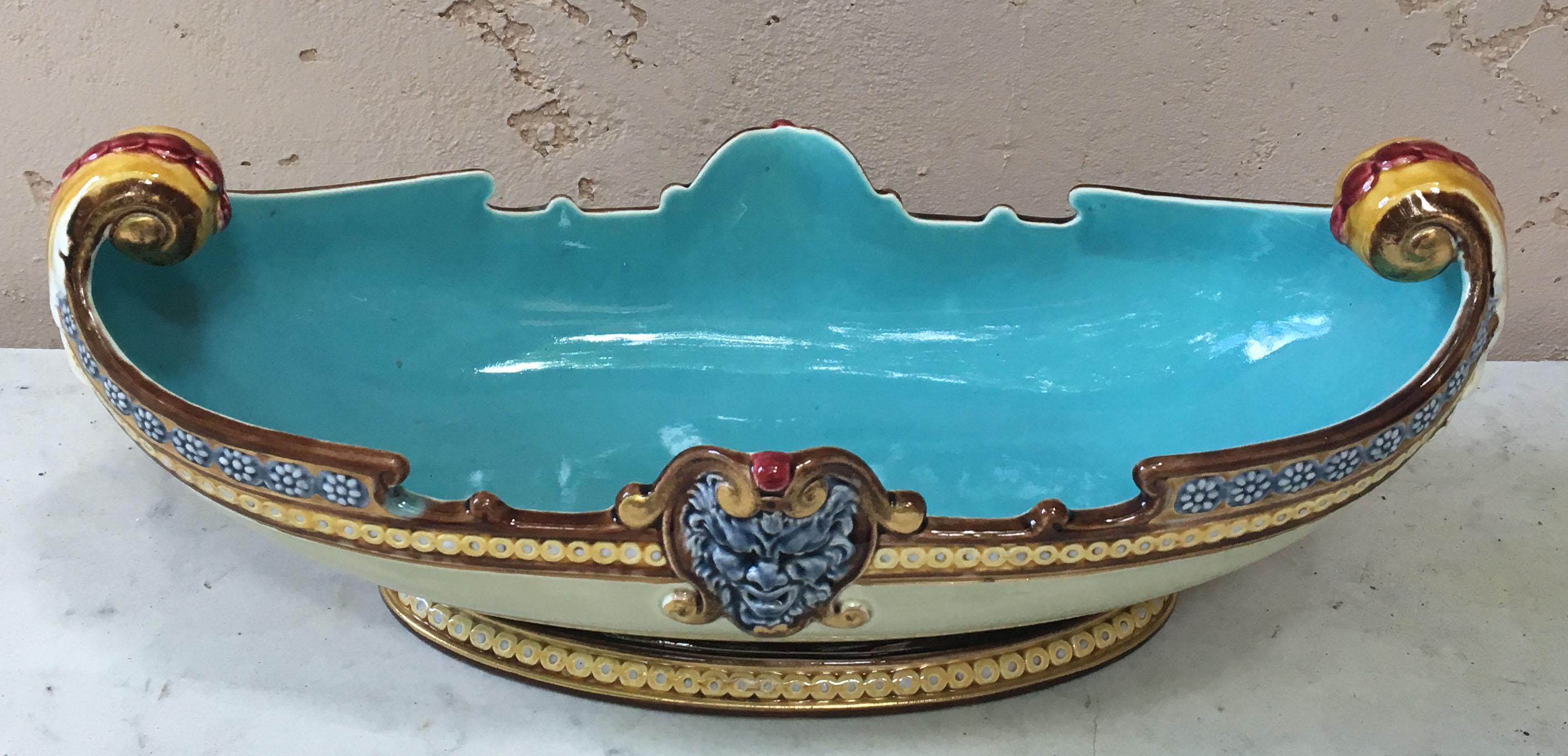 Majolica jardinière in a gondola shape with a masks on the two sides signed Sarreguemines number 1972, circa 1880.