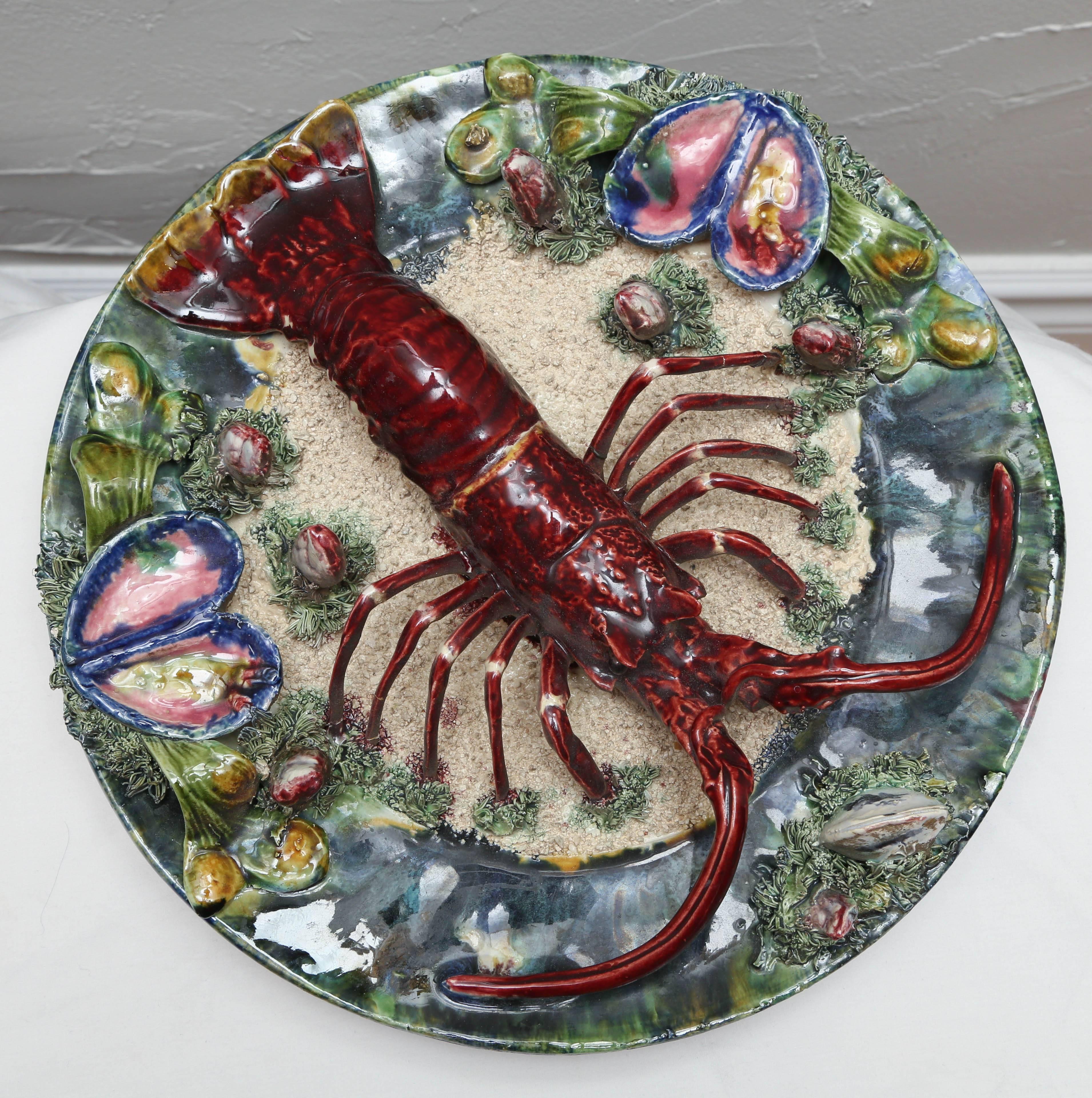 Three dimensional Majolica dish centered with a large lobster and surrounded by oysters. Signed Caldas, Portugal on reverse side.