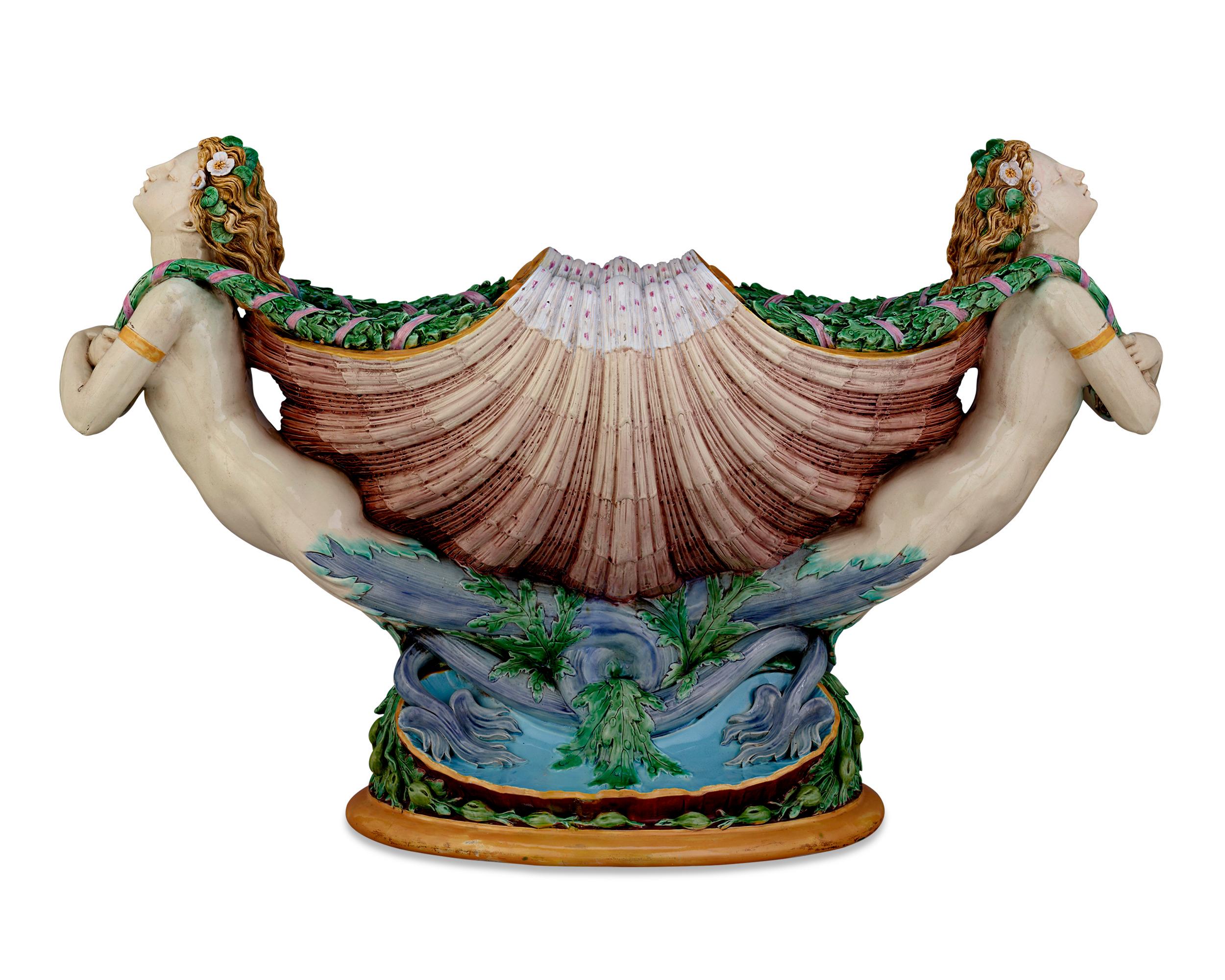 This monumental majolica jardinière by Minton represents the artistic heights of this highly important British firm. The design, which features two mermaids supporting a scallop shell, was used by Minton to represent their creations in majolica at