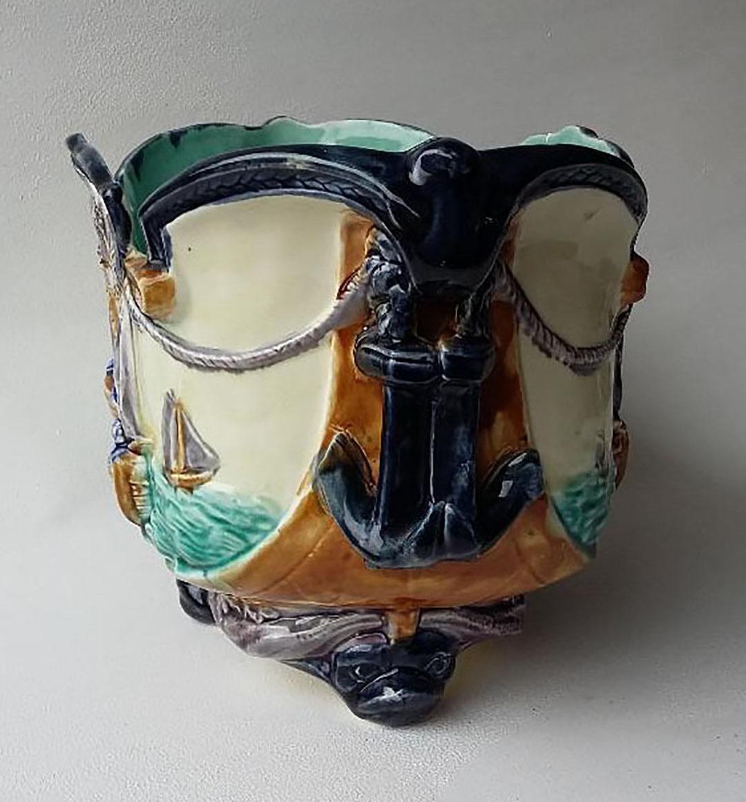 19th century, large Majolica Nautical jardinière signed Onnaing, the feets are dolphins and the front is decorated with boats on the sea, the handles are anchors.