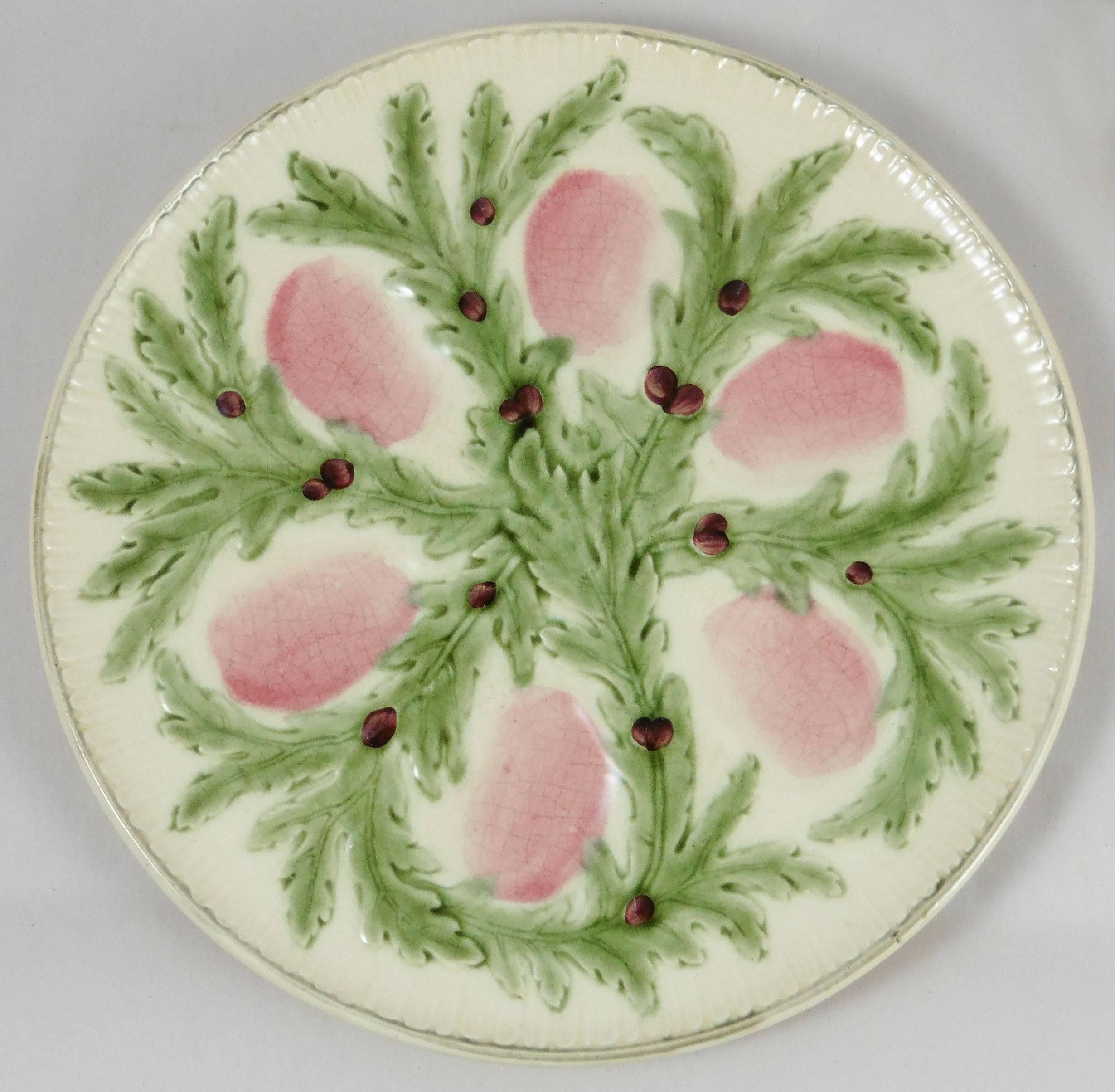 Very decorative Majolica oyster plate signed Hippolyte Boulenger Choisy le Roi. The six pink wells are surrounded by green seaweeds.
