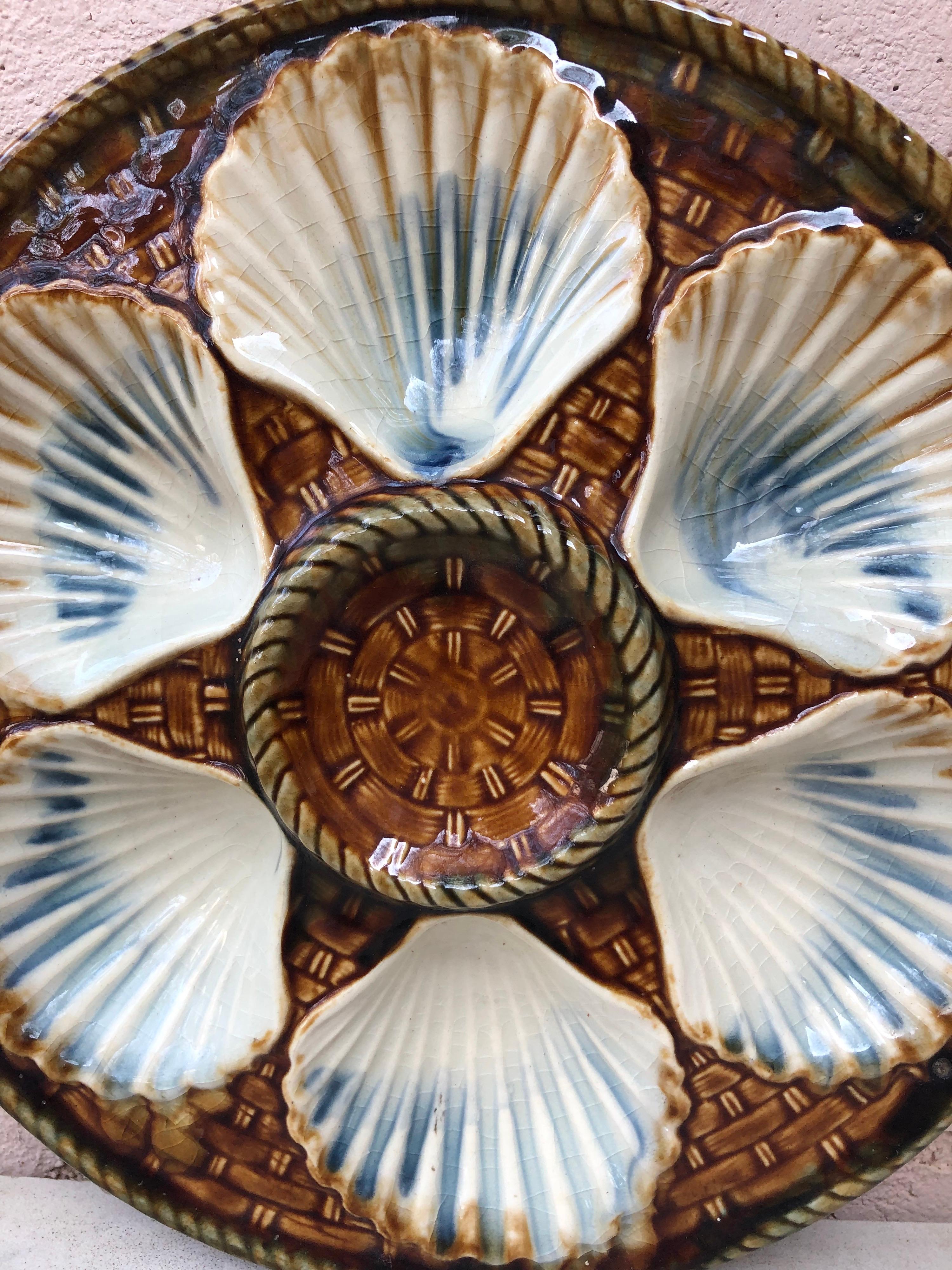 Rare yellow Majolica oyster plate, six white wells on a yellow basket weave, circa 1890 signed Longchamp.