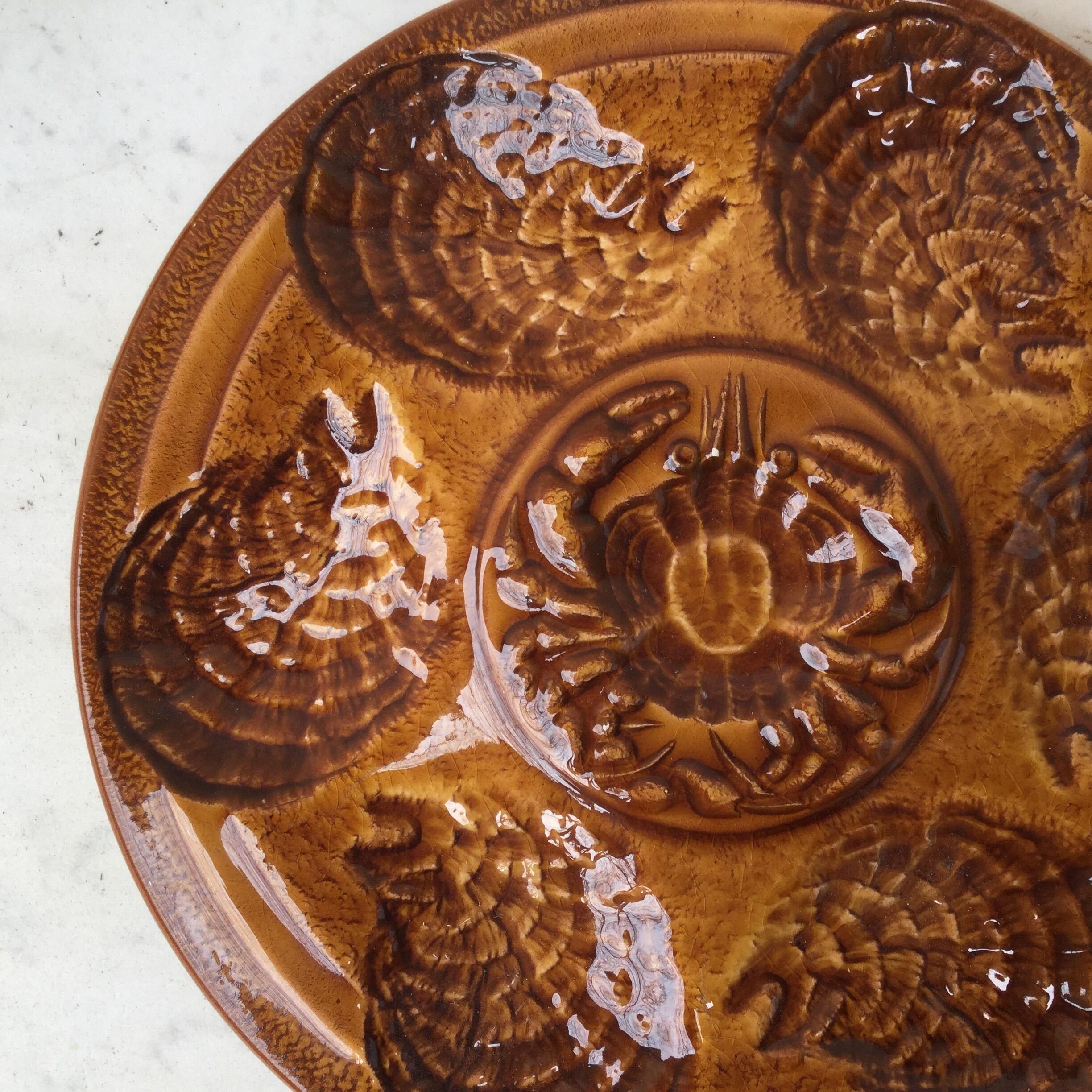 Majolica oyster plate with crab in the center and shell accents, circa 1960 signed Sarreguemines.