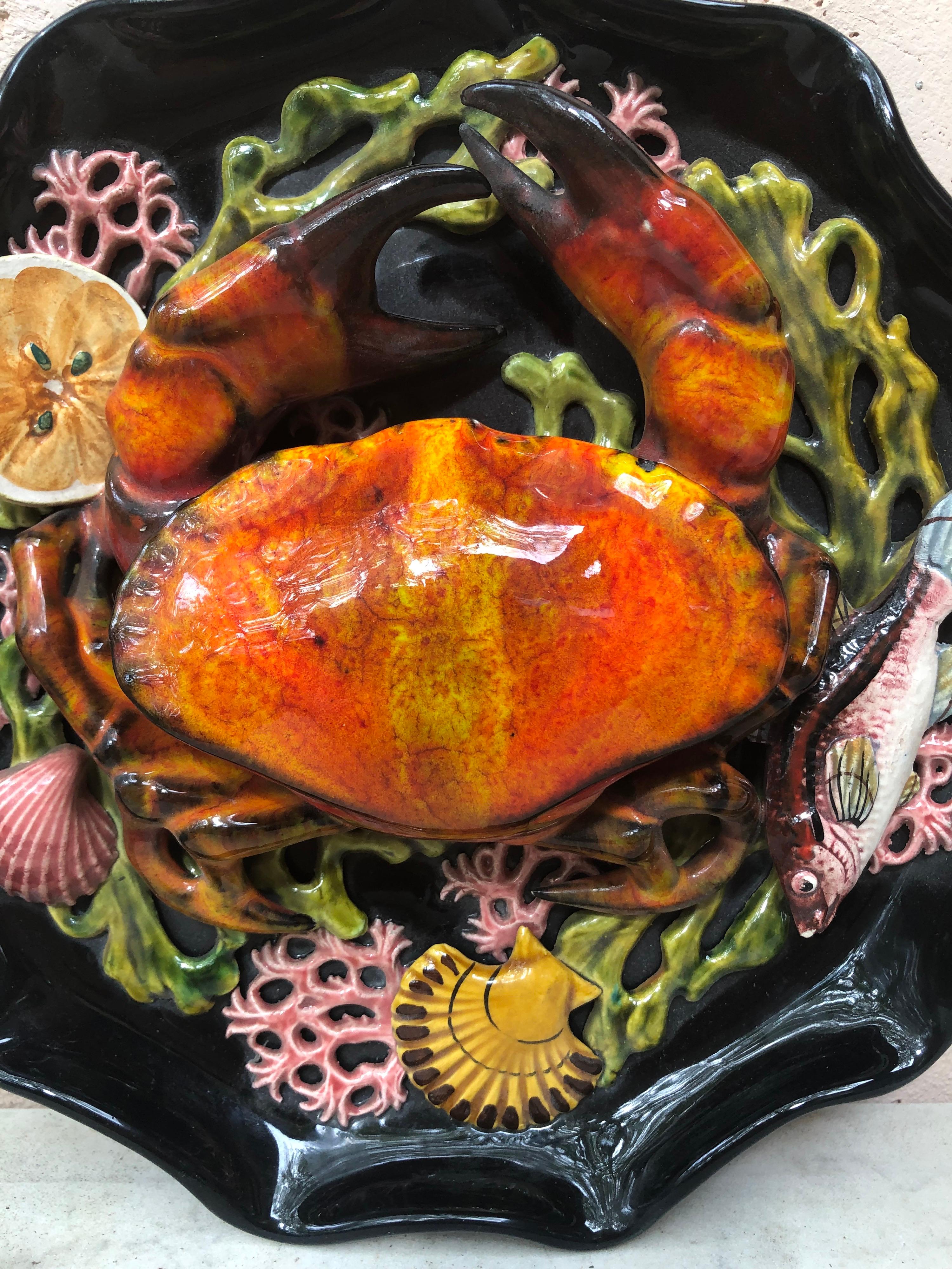 Large Majolica wall platter attributed to Vallauris, circa 1950.
A large crab in high relief on the center surrounded by seaweeds, one fish, shells and a slice of lemon.