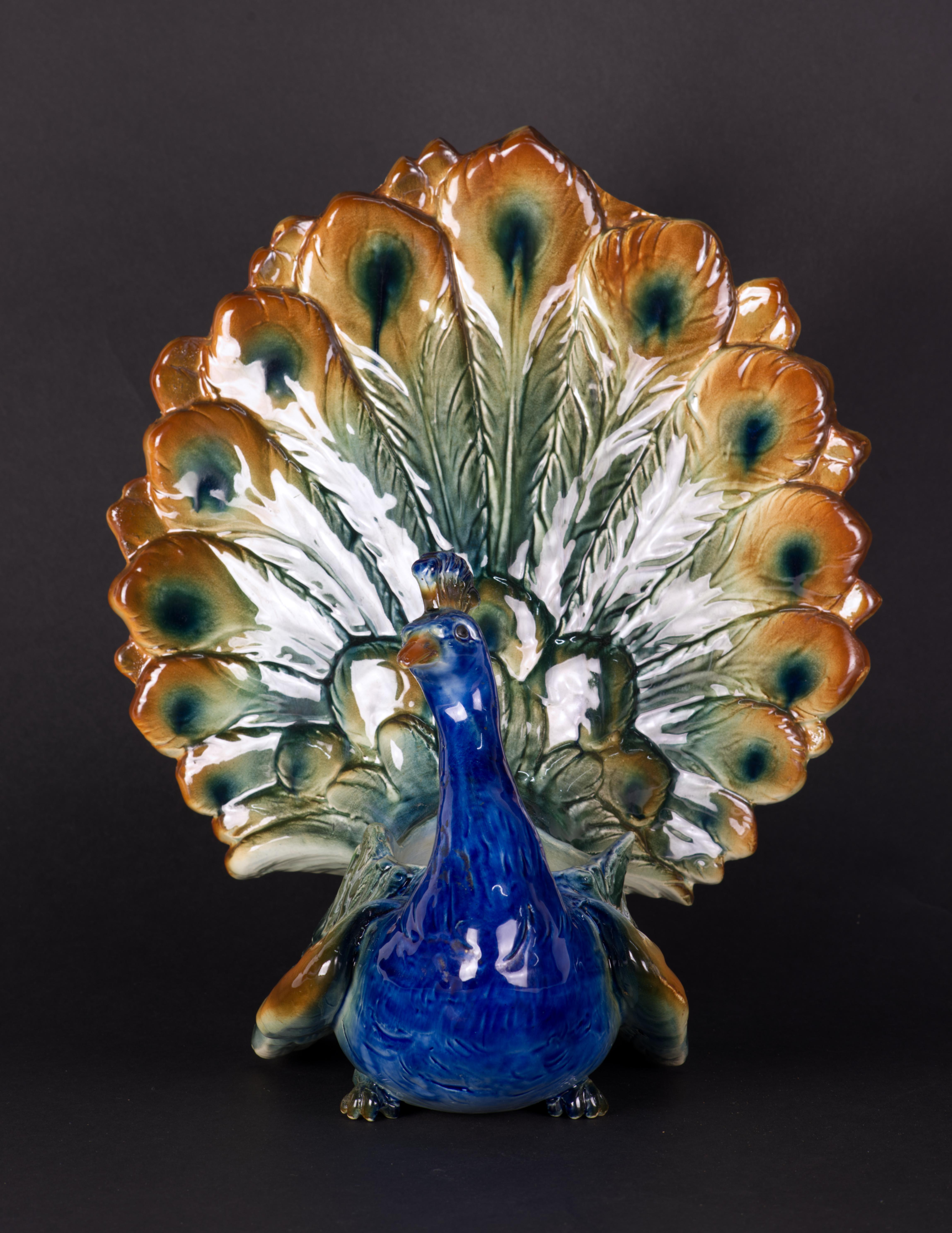  Rare majolica peacock shaped jardiniere or planter in Art Deco style was made by St Clement in Luneville, France. The figural planter features richly detailed surfaces, especially on tail and wing feathers, that are enhanced by hand-painted decor