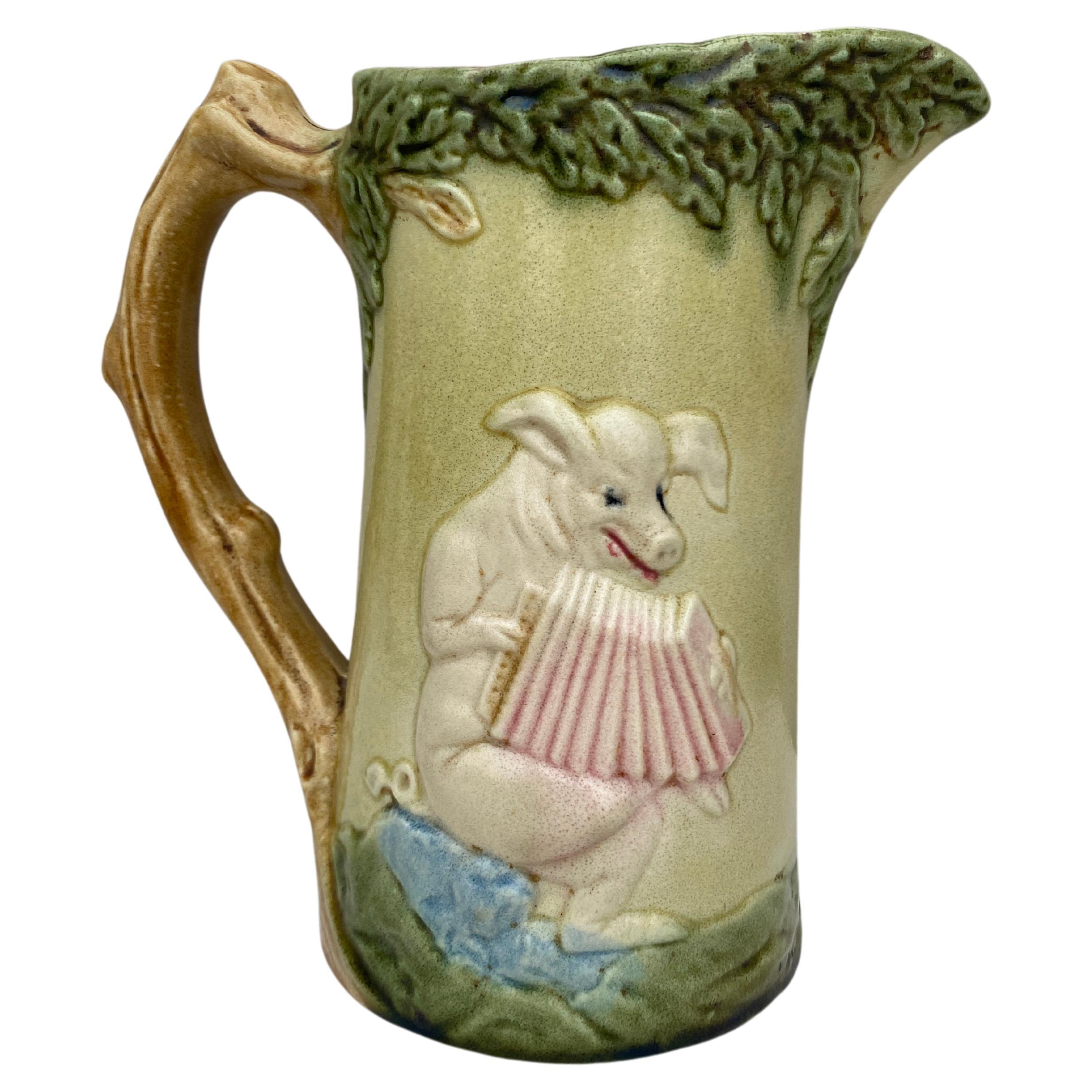 Rare French Majolica pigs signed Orchies, circa 1900.
One side with dancing pigs , the other side with a pig playing Accordion.