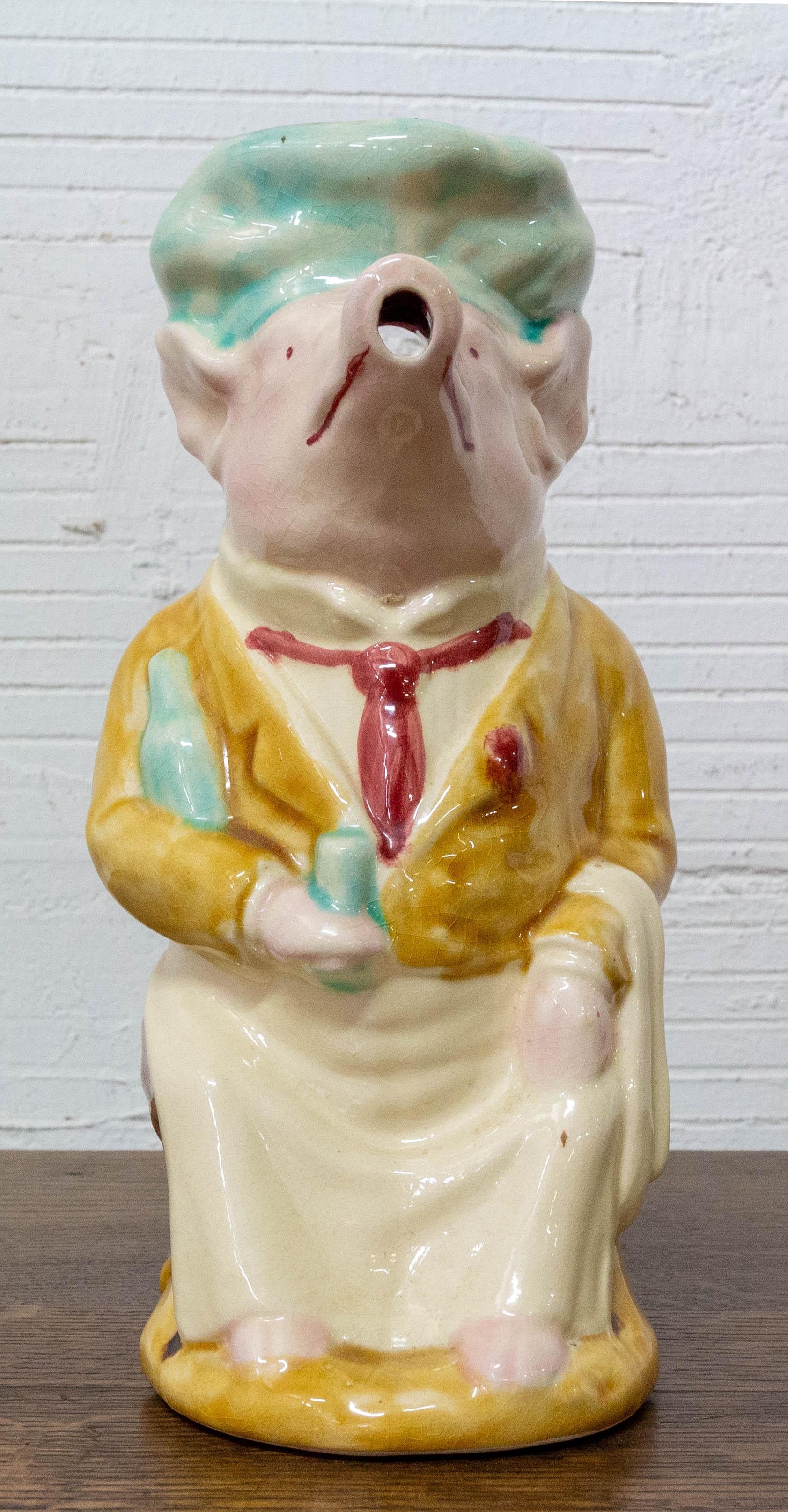 French Majolica pig dressed as a waiter signed FFAS, circa 1900.
Onnaing style
Barbotine pitcher

Good condition

Shipping 
P 19/ L 12/ H 26 cm.