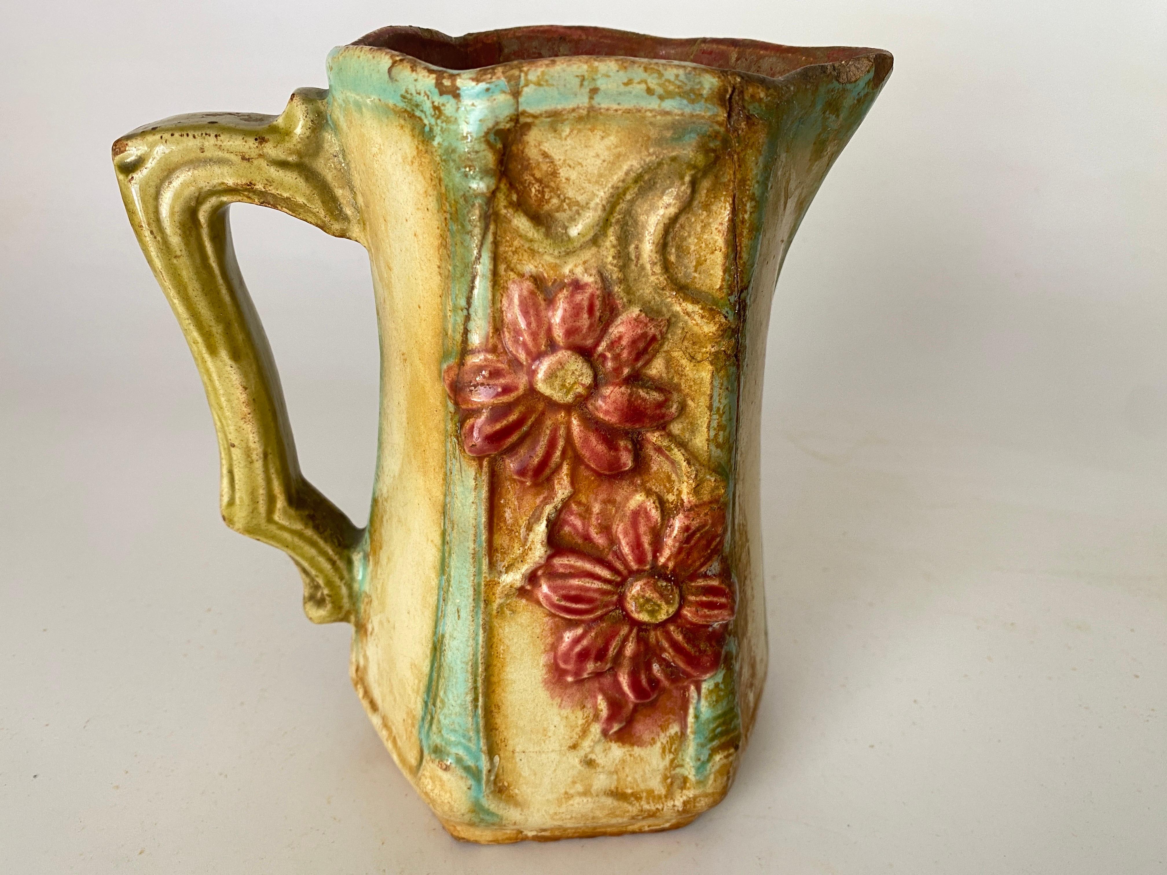  Designed with large green leaves and Red flowers. The top neck with handle circa 1900.