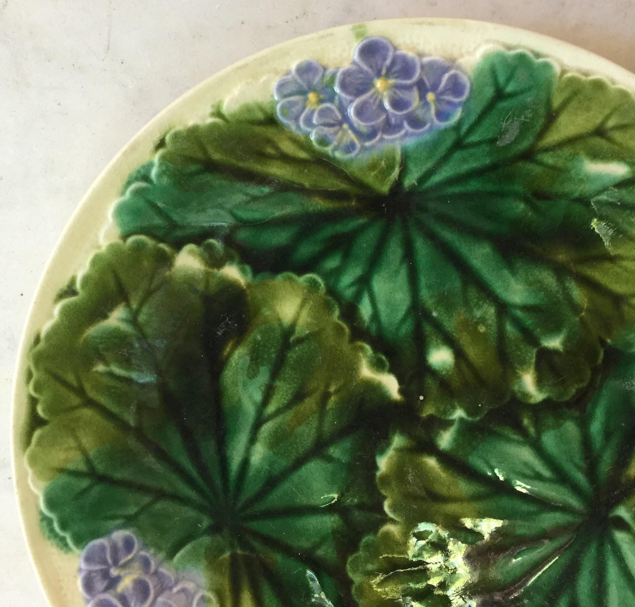 Majolica purple flowers plate signed Clairefontaine, circa 1890.