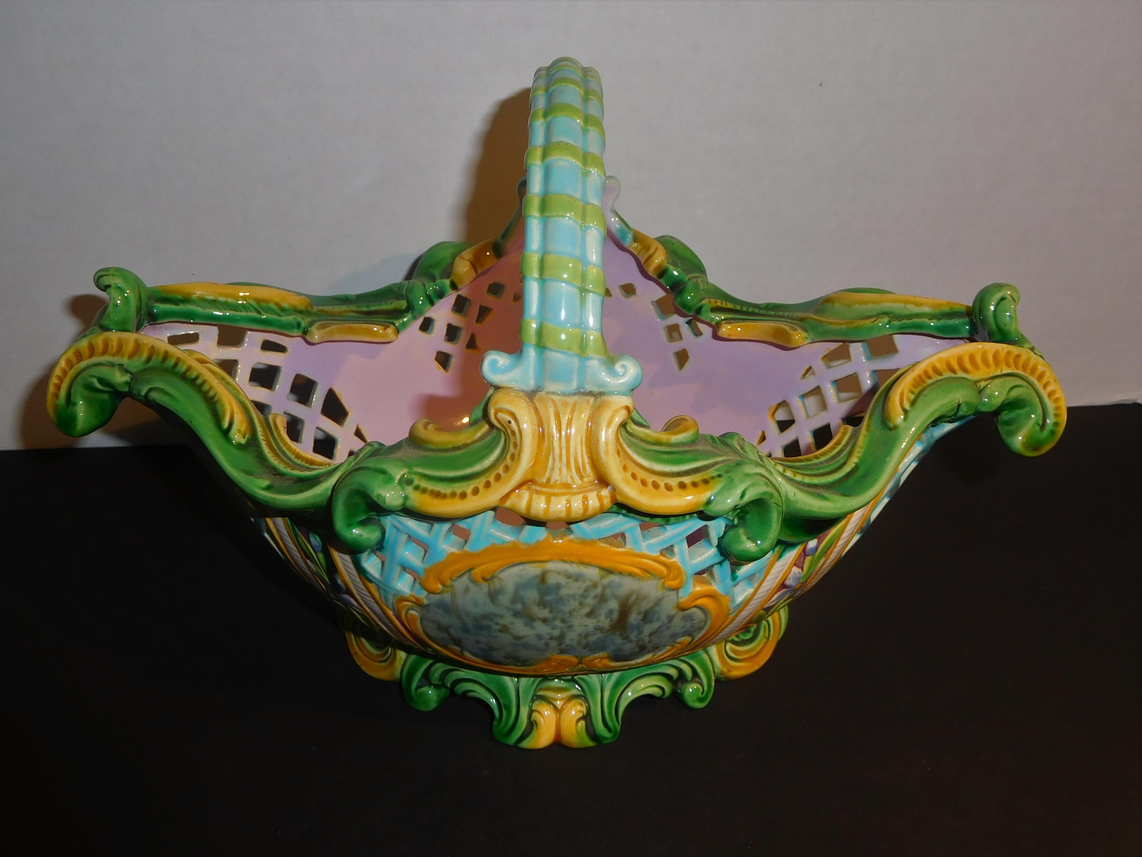 This majolica berry basket has reticulated sides to allow air flow around the fruit. The detailed handwork is meticulous and the colors are fanciful, with a lavender interior and blue, green, yellow and grey exterior. The basket is unmarked, but I