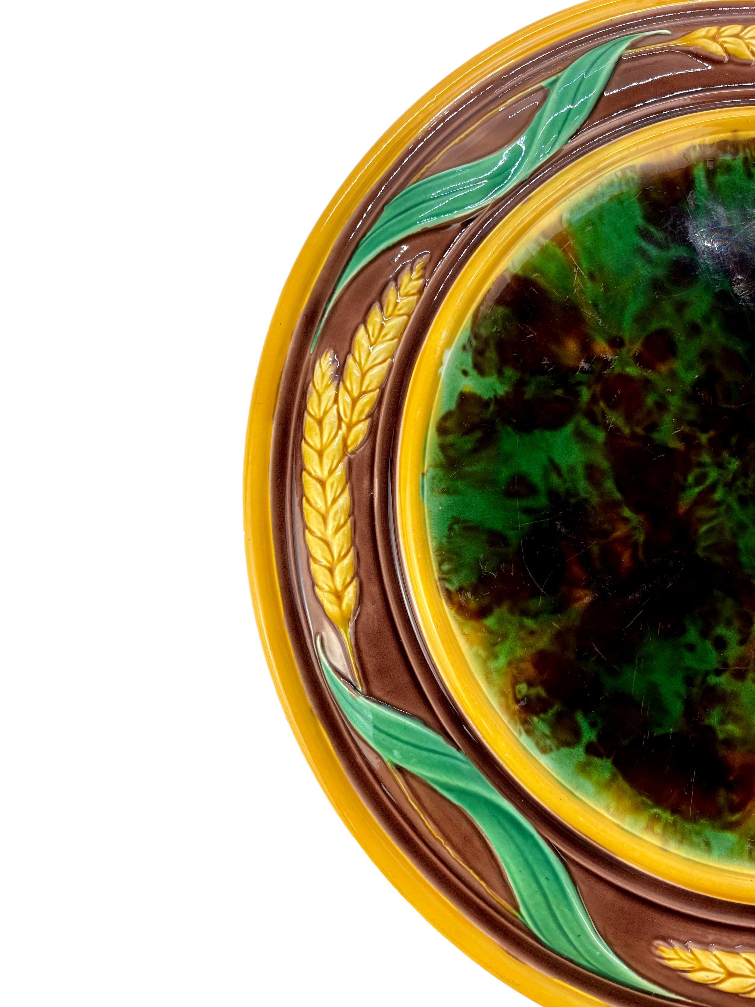 T. C. Brown-Westhead, Moore & Co. Majolica Bread Platter, of round form, the mottled center, banded in yellow, the outer border with yellow wheat sheaves molded in high relief, the reverse glazed in turquoise, with impressed 'M' and painted design