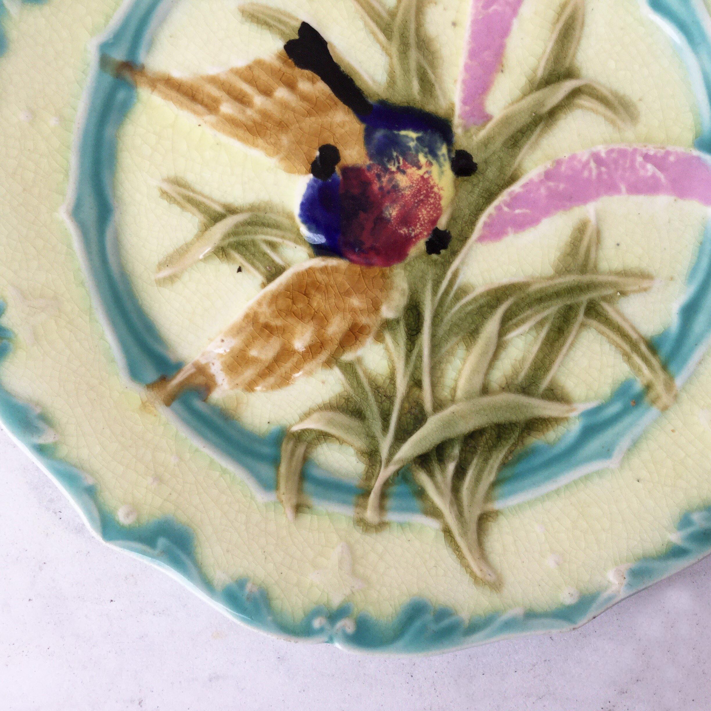 Lovely Majolica plate with bird and insect, leaves signed Saint Amand, circa 1890.