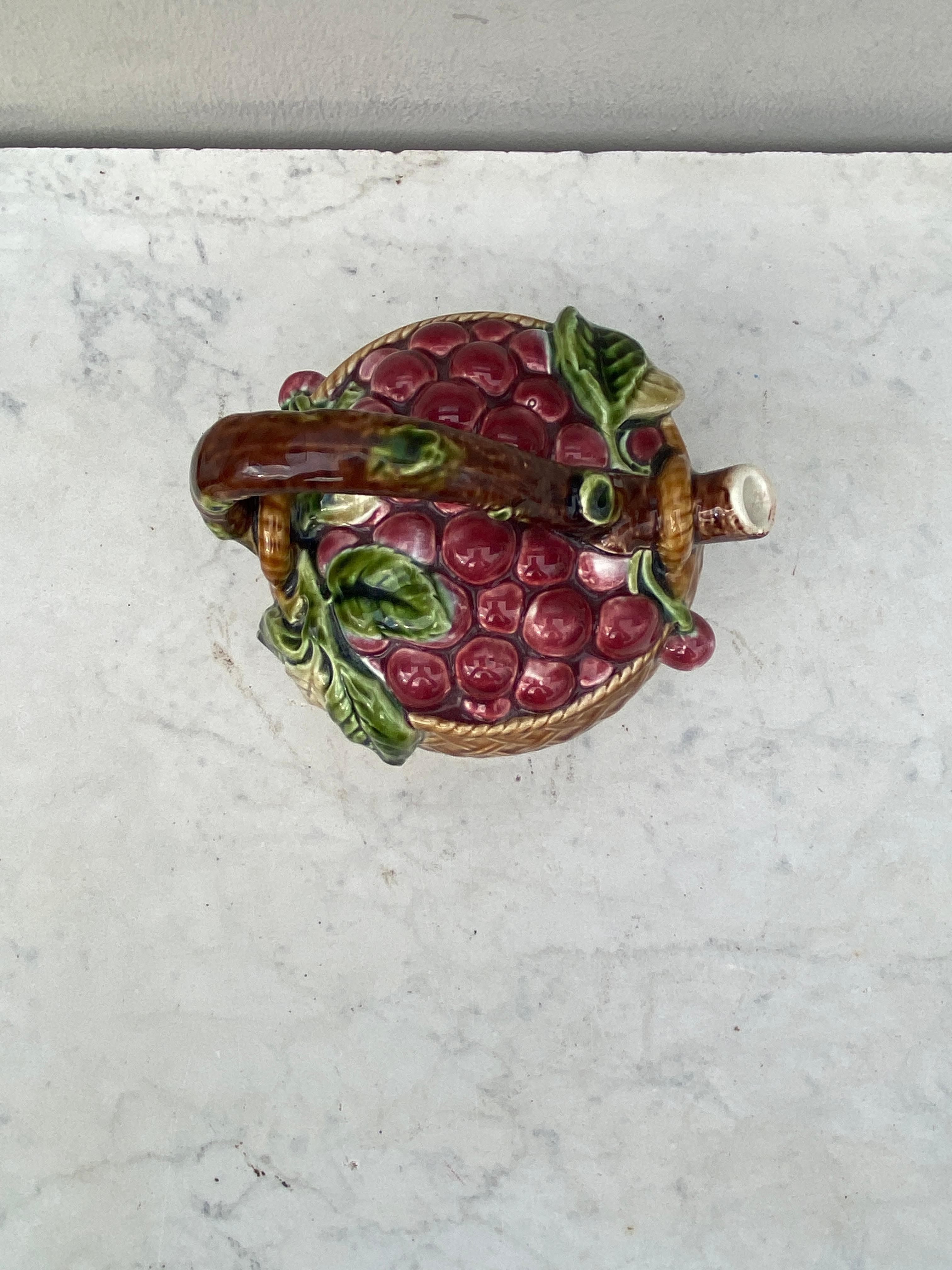 Majolica Sarreguemines Cherries Pitcher, circa 1900.
Made for the liquors company Cuisenier , Cusenier is a French spirits brand, whose distillery house was founded in Ornans (Doubs) by Eugène Cusenier under the name of E. Cusenier, Fils aîné et Cie