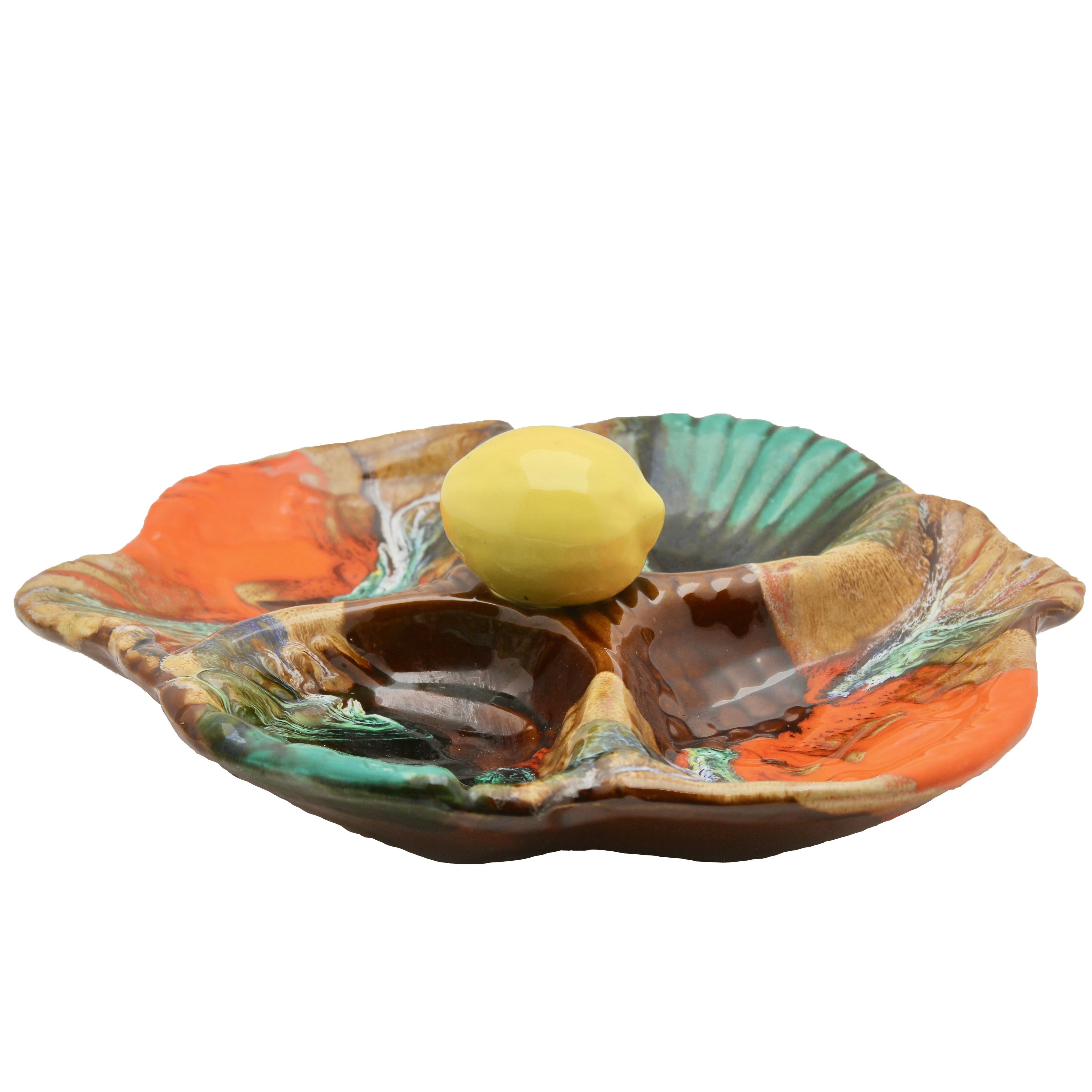 Majolica-style oyster plate or seafood platter by Vallauris Faience with a traditional-style impressed design but a distinctly midcentury decor of 'fat-lava' glazes.

The earthenware shape underneath the glazes shows a typical impressed design of