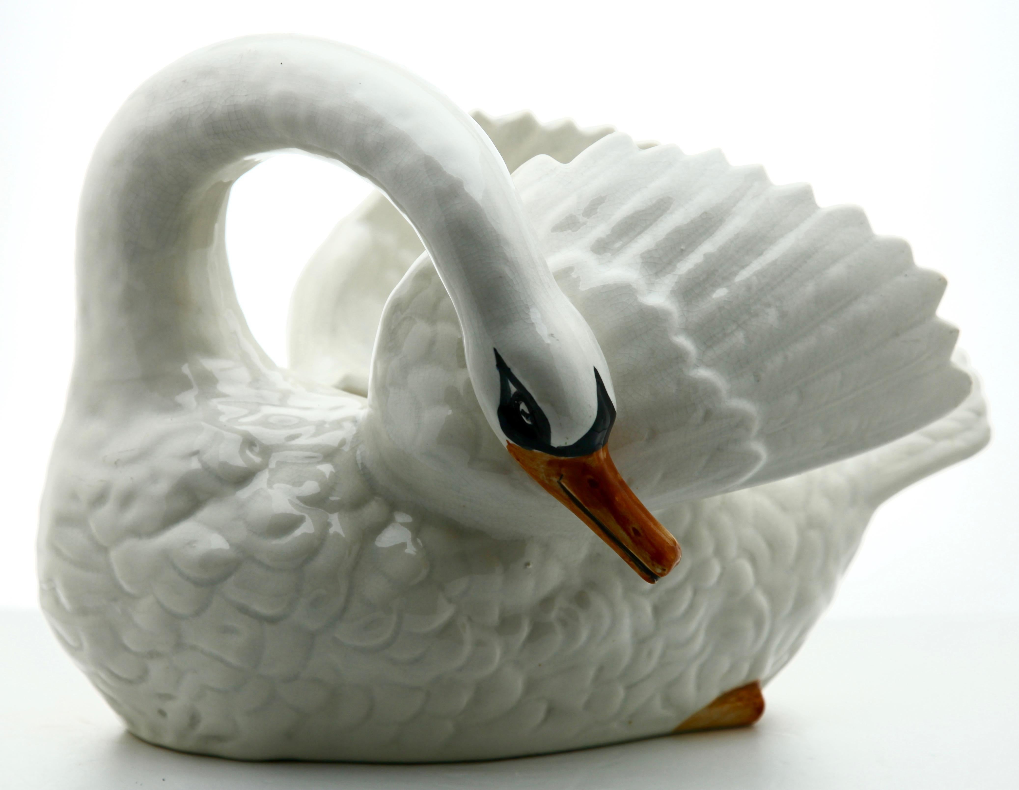 Majolica white swan jardinière Nimy, circa 1900.

Stamped: Nimy Faiences imperiale 1789-1951 Belgium.
A real treasure for the ceramics' collector.

    

  
  