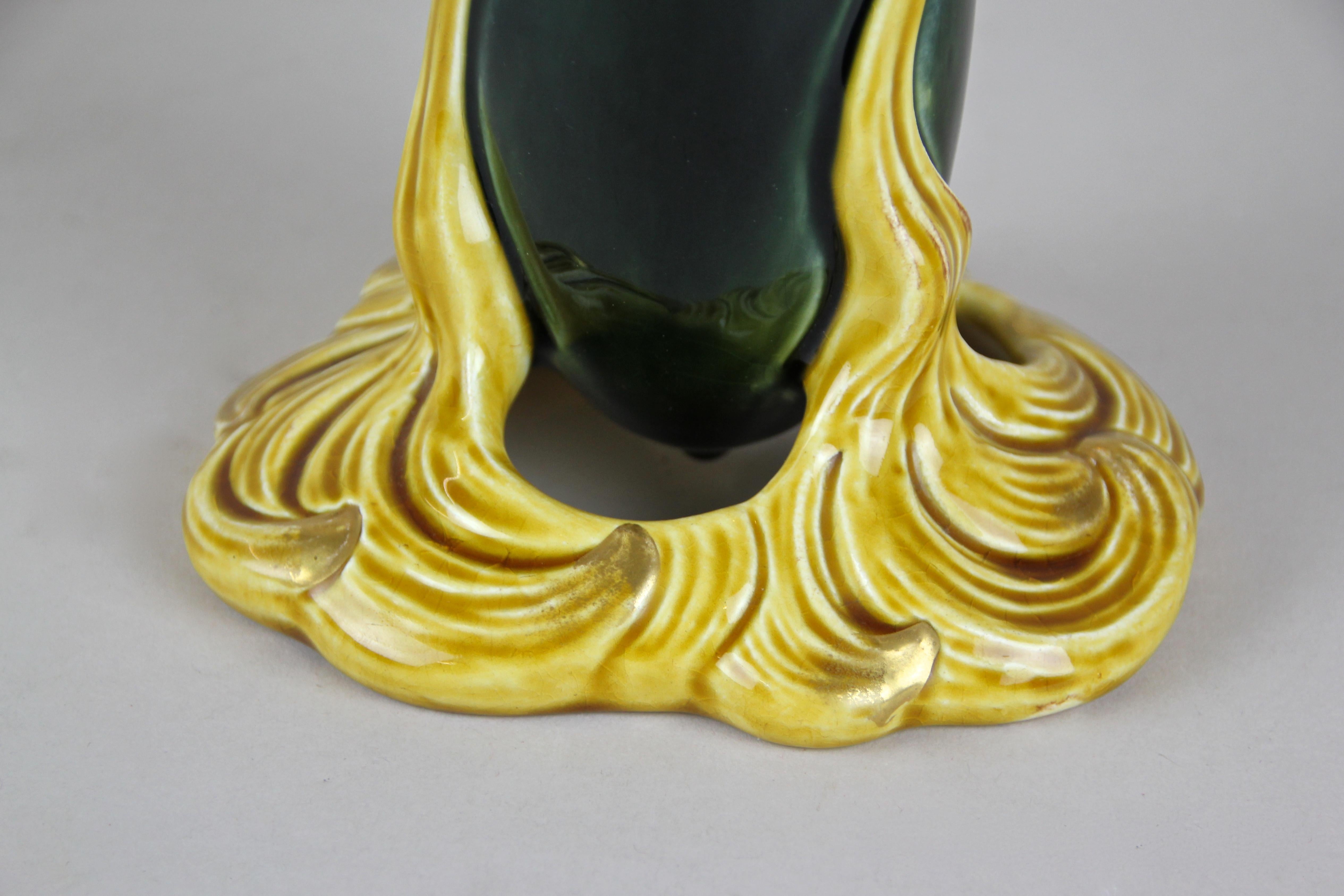 Out of the workshops of Sarreguemines in France around 1915 comes this beautiful slim Art Nouveau Majolica vase. The organic design impresses with its extraordinary twisted shape alongside a great looking glazed surface in nice yellow and very dark