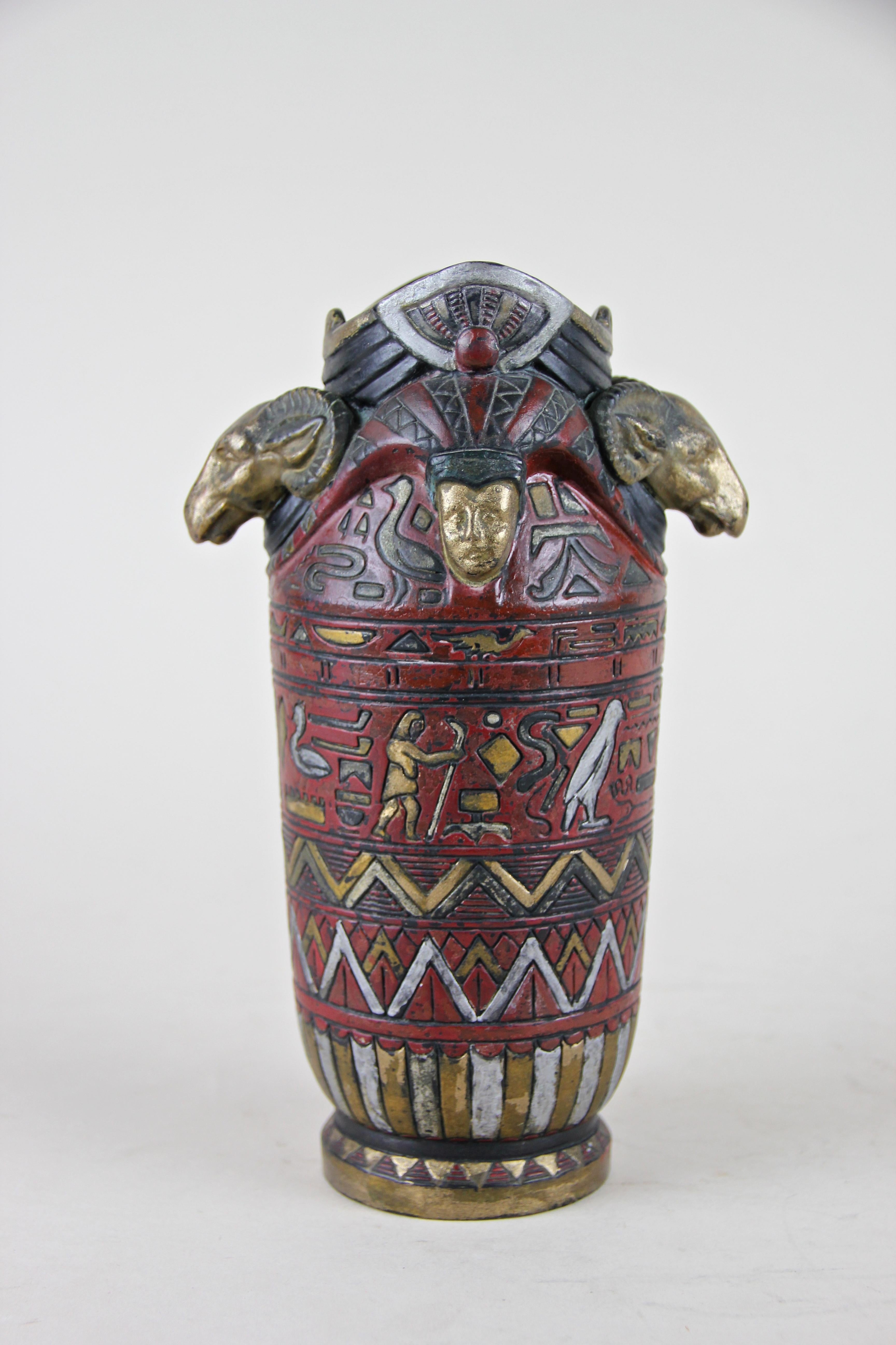Beautiful rare Majolica vase by Julius Dressler, circa 1895. The fantastic art pottery Egyptian styled vase comes with a dark red body crested with great designed hand painted hieroglyphs. On top two golden ram / pharaoh heads impress every