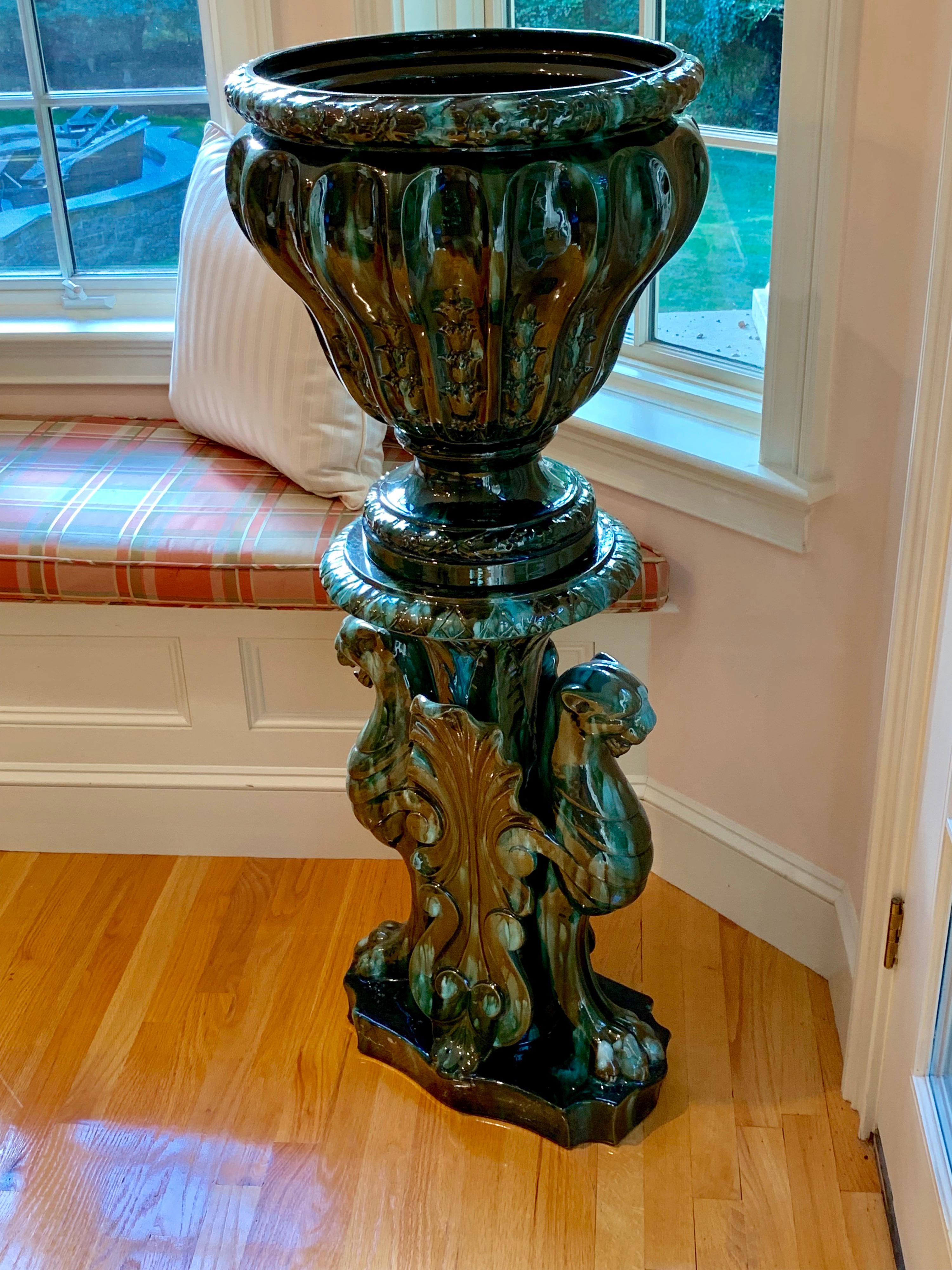 French neoclassical Majolica urn on stand by Clement Massier, circa 1890.
The tripod like base has 3 stylized lions, the green/blue hues of this vase are magical as the light hits them, changing the color depending on the reflection.